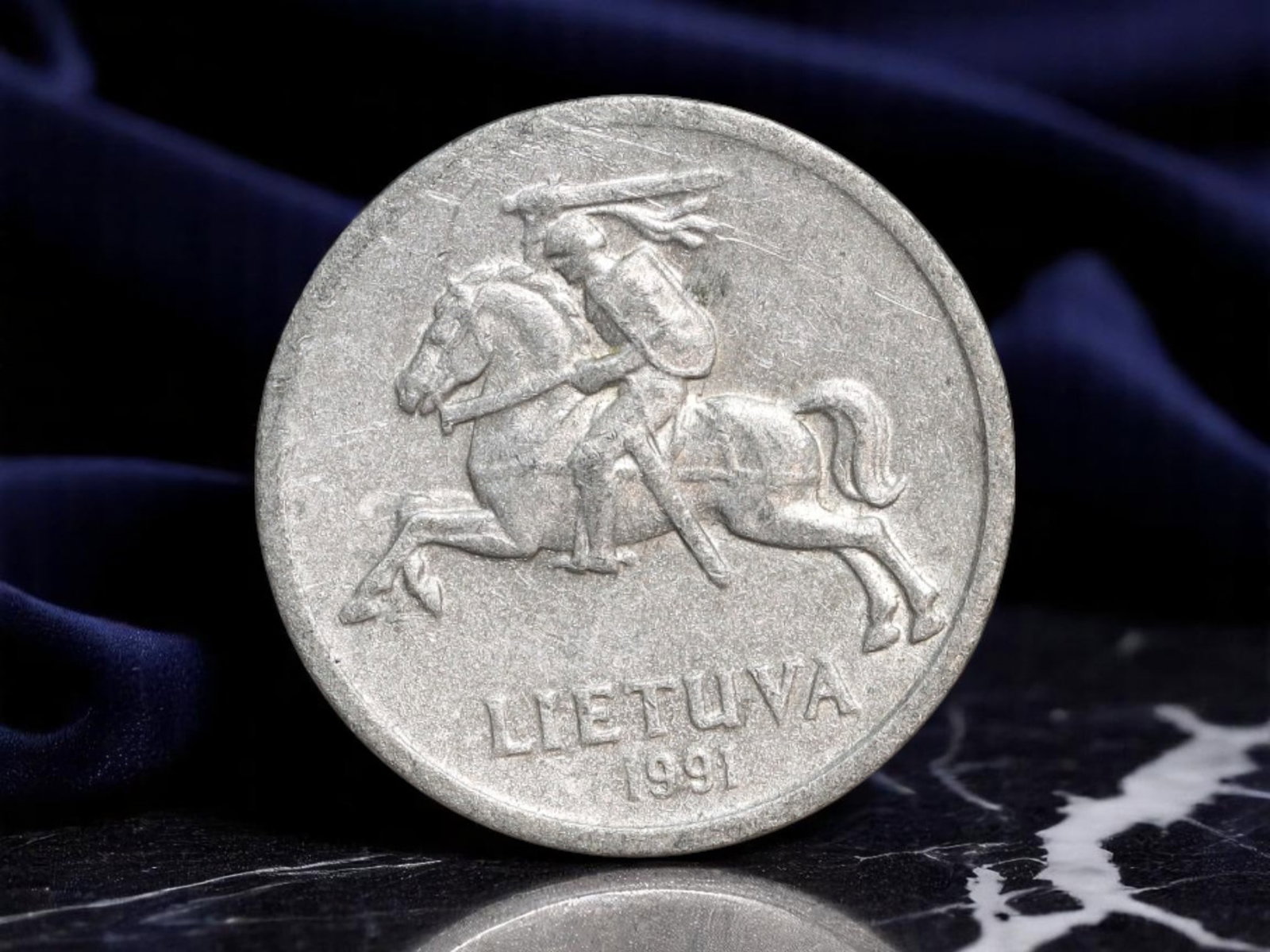 LITHUANIA: National Rebirth - Vytis Horseman 1 Centas Coin, 1991, 18mm: Issued in the pivotal year of 1991-the same year Lithuania declared full independence from the collapsing Soviet Union-this 1 Centas coin is steeped in symbolic resurgence. The obverse features the le