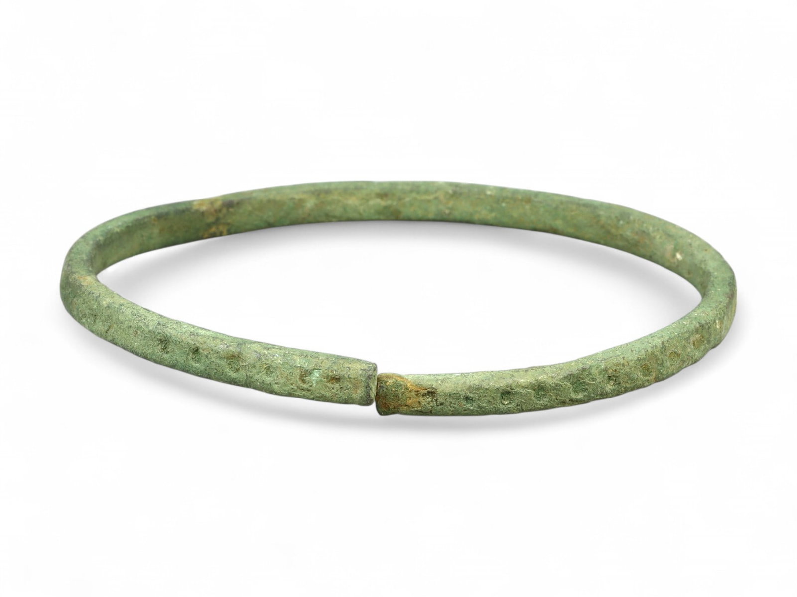 Ancient Roman Bronze Armilla Bracelet with Subtle Textured Band, c. 1st-3rd Century CE: This understated yet compelling bronze bracelet dates to the height of the Roman Empire, c. 1st-3rd century CE. Crafted in the traditional armilla style, it features a uniform circular form with subtl