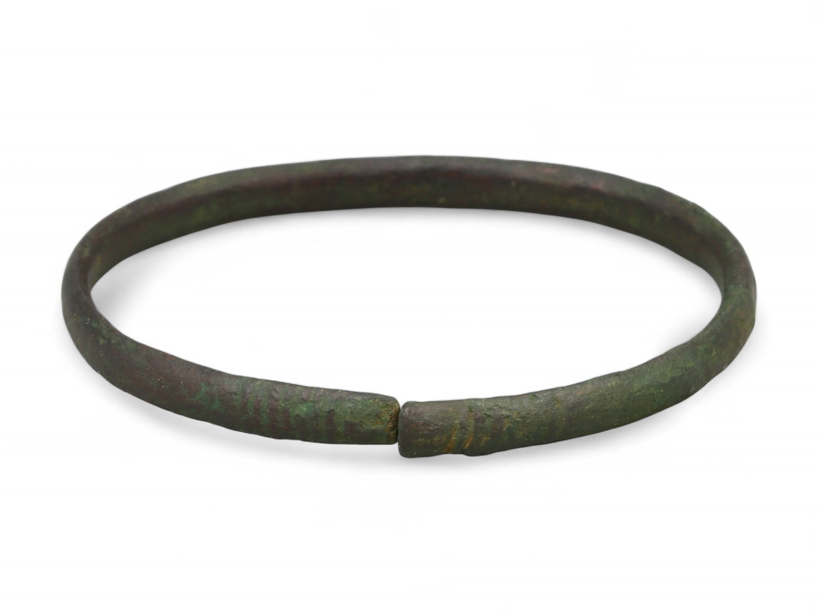 Ancient Roman Coiled Armilla Bronze Bracelet, c. 1st-2nd Century CE: This refined bronze bracelet exemplifies the Roman tradition of armillae, dating to the 1st-2nd century CE during the height of the Roman Empire. Fashioned in a closed-loop form with a subtle coiled a