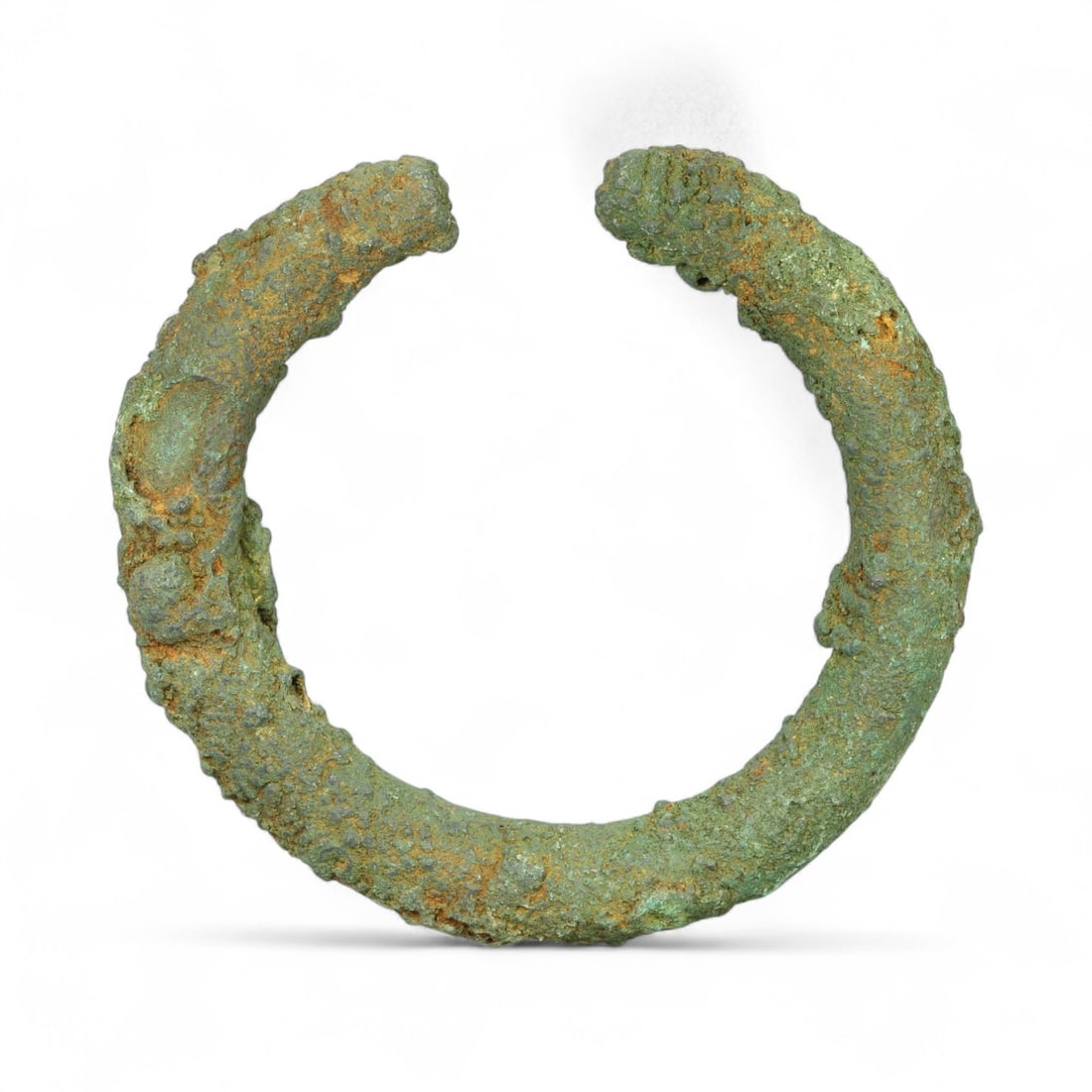 Ancient Celtic Tribal Bronze Power Armlet, c. 3rd-1st Century BCE: This exceptionally hefty bronze bracelet, dated to the 3rd-1st century BCE, stands as a formidable expression of early Celtic craftsmanship and tribal identity. Cast in a thick, solid form and worn op