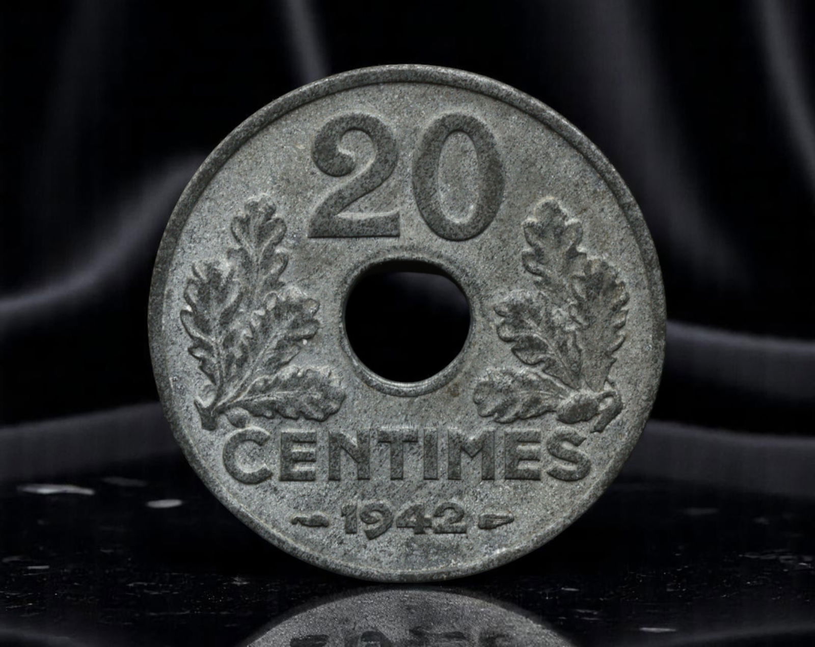 FRANCE: Vichy Regime - Etat Francais 20 Centimes Coin, 1942, 24mm: Minted under the authoritarian Vichy regime during Nazi occupation, this 1942 20 Centimes coin reflects the stark rebranding of state ideology. The phrase ETAT FRANCAIS (French State) replaces the rep