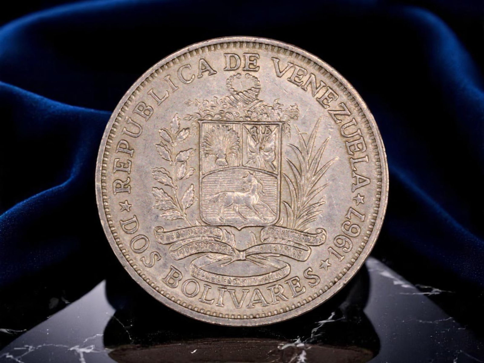 VENEZUELA: Bolivar the Liberator - Republican Sovereignty Silver 2 Bolivares Coin, 1967, 26.8mm: Struck in 1967 at the height of Venezuela's modern republican era, this silver 2 Bolivares coin immortalizes the enduring legacy of Simon Bolivar, the Liberator, whose neoclassical profile dominates o