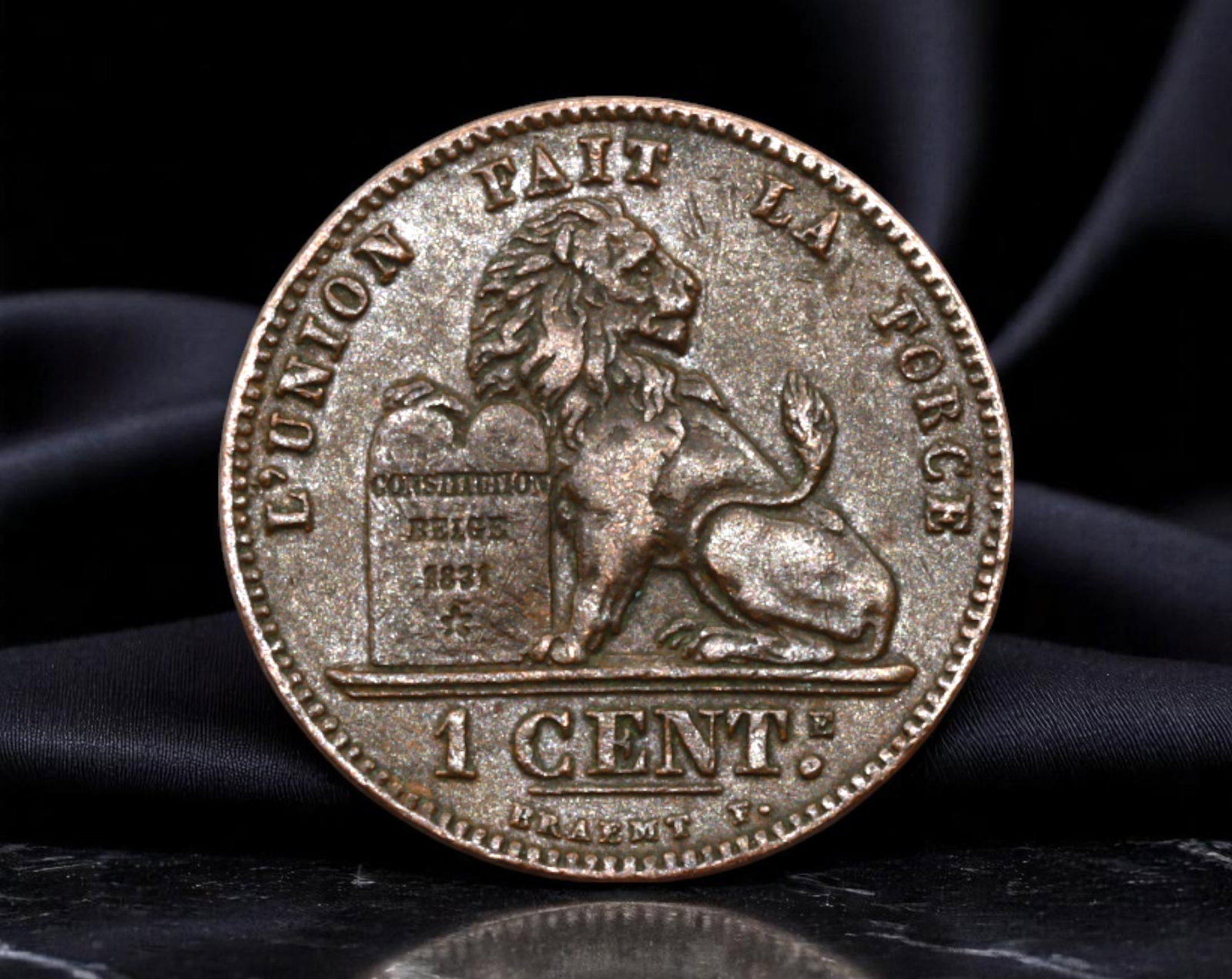 BELGIUM: Constitutional Strength - Leopold II Lion & Charter 1 Centime Coin, 1907, 16mm: Struck in 1907 under King Leopold II, this 1 Centime coin combines regal authority with republican ideals. The reverse features a vigilant lion seated beside the Belgian Constitution of 1831, surmount