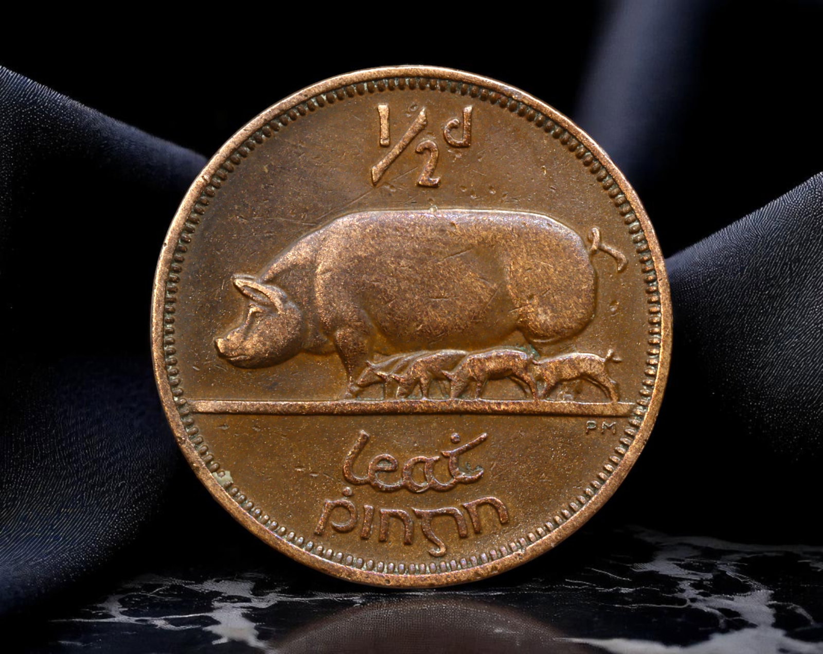 IRELAND: Agricultural Identity - Irish Free State Sow Halfpenny Coin, 1937, 25mm: Struck in the formative years of the Irish Free State, this 1937 halfpenny coin vividly reflects the nation's agrarian foundations. The reverse depicts a nurturing sow with a line of piglets-a pastora