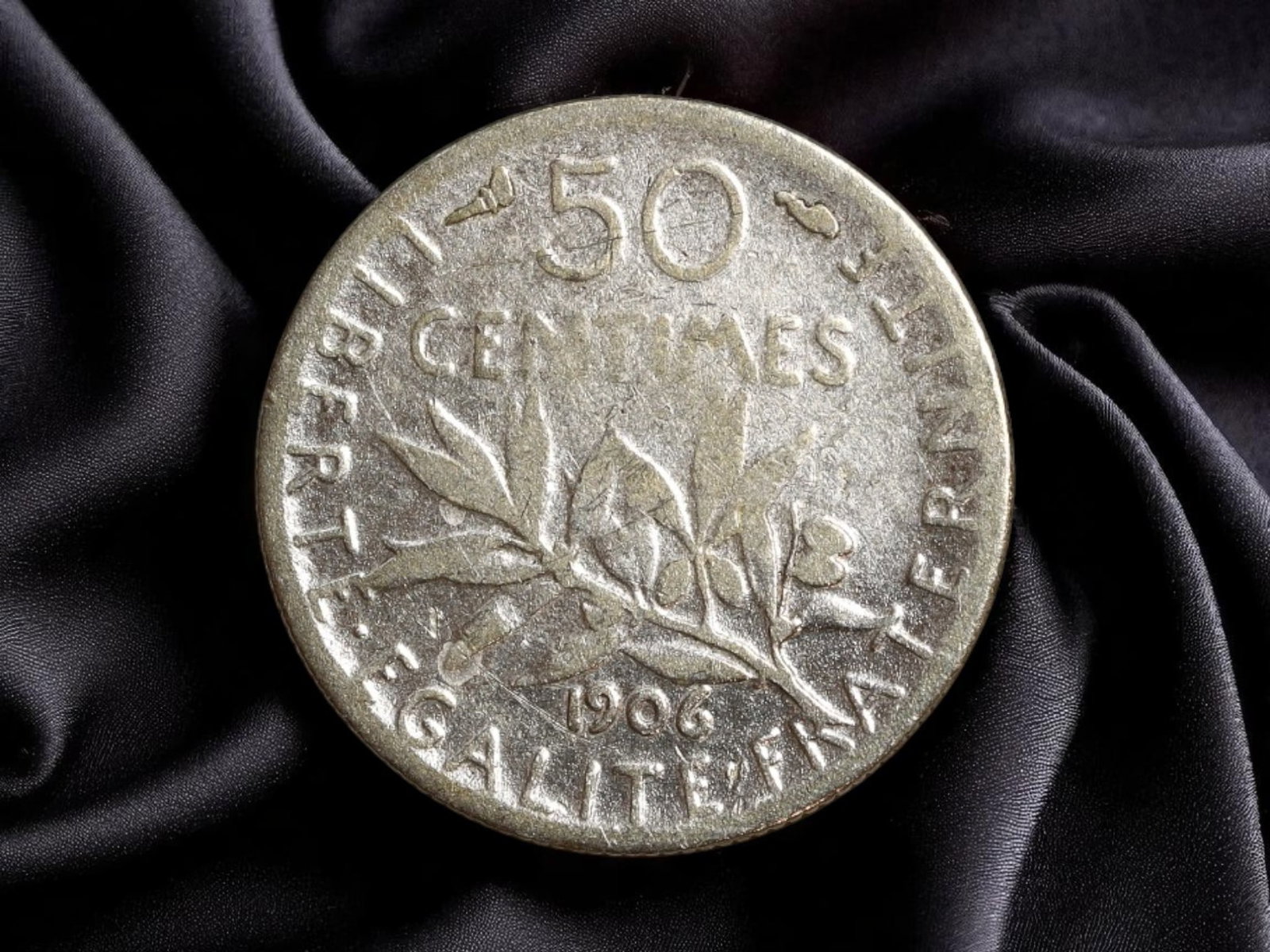 FRANCE: Third Republic - Liberty Seated 50 Centimes Coin, 1906, 18mm Silver: Struck in 1906 during the French Third Republic, this 50 Centimes silver coin stands as a graceful embodiment of national identity rooted in republican ideals. Rendered in finely detailed silver, the 