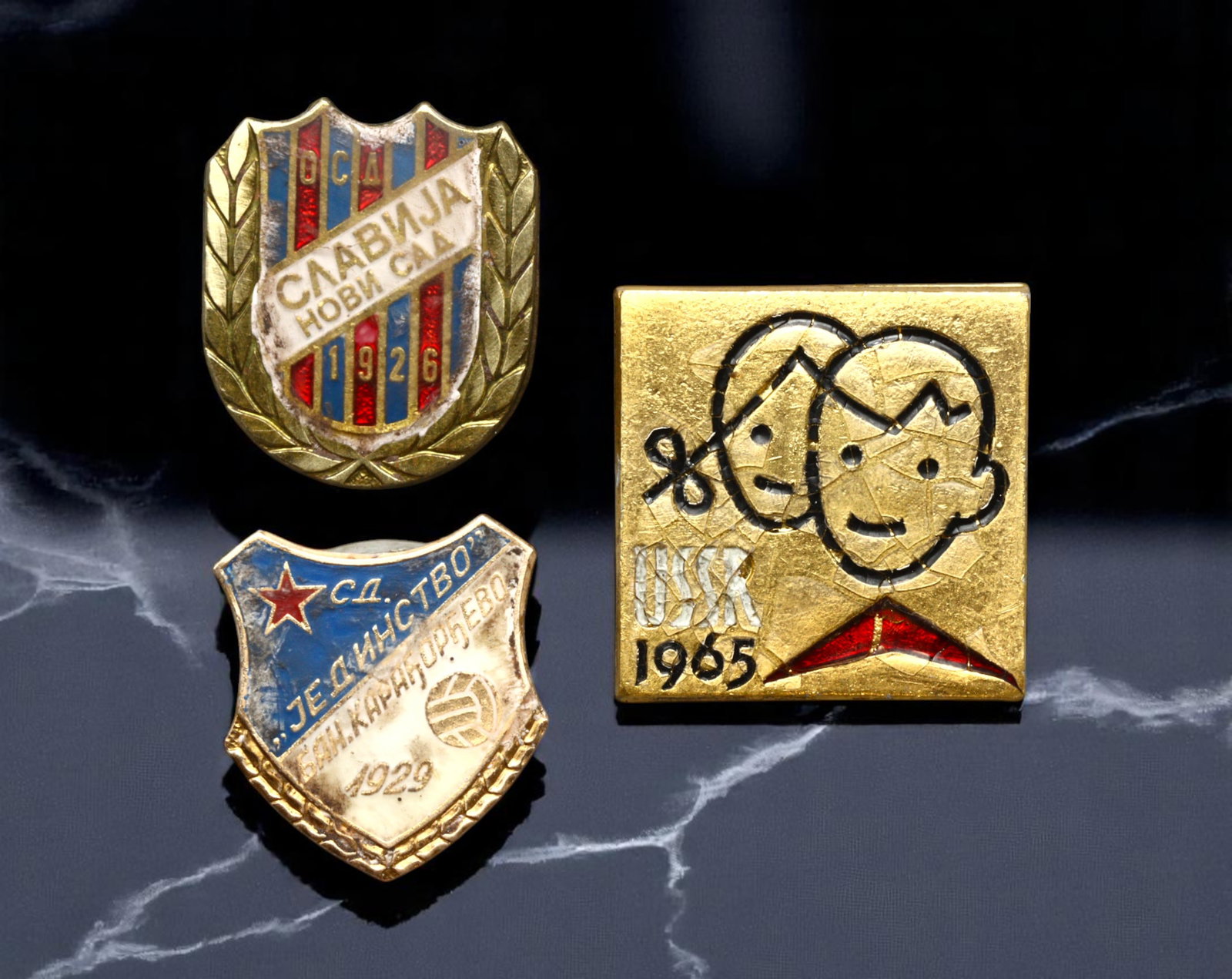 YUGOSLAVIA: Slavija Novi Sad, Jedinstvo Kanjiza and USK Children's Event Badges, 1965-1970s, 16-18mm: This charming trio of Yugoslav badges reflects the vibrant social and athletic culture of the era. The Slavija Novi Sad badge, bordered by laurel leaves, commemorates the founding of the famed sports 