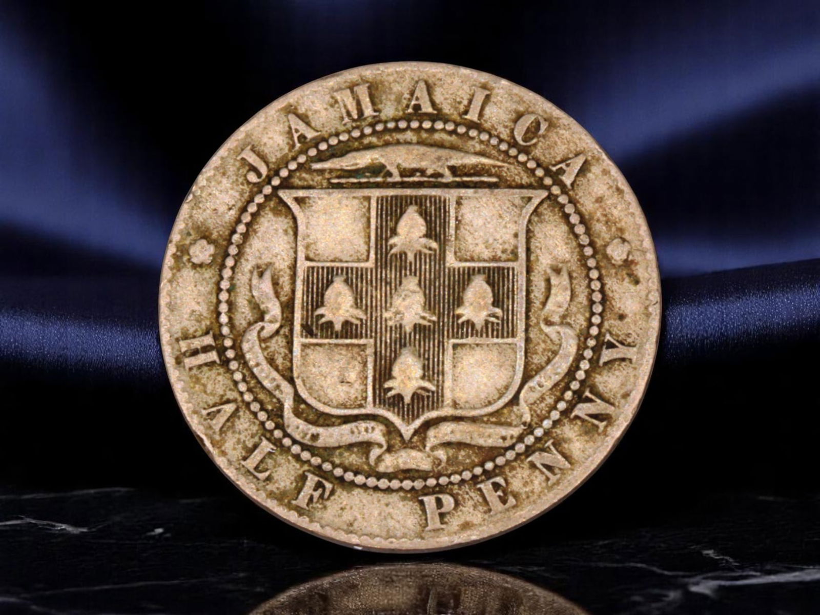 JAMAICA/BRITISH WEST INDIES: Edward VII - Colonial Arms Half Penny Coin, 1907, 25.2mm: Struck in 1907 during the waning years of British imperial grandeur, this Jamaican half penny coin reflects both colonial authority and local identity. The obverse features the crowned effigy of King