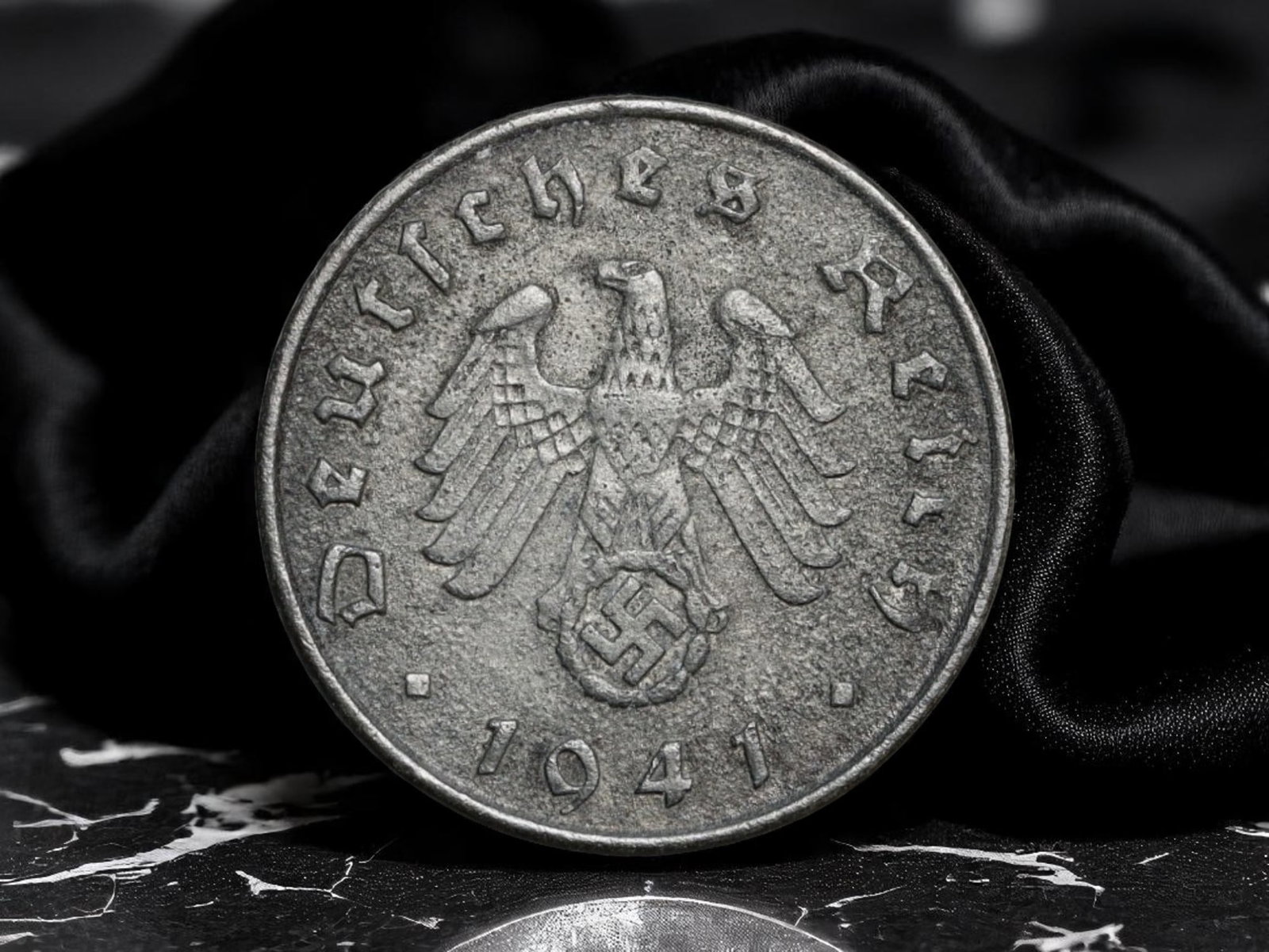 GERMANY/THIRD REICH: Wartime Economy - Reichsadler 5 Reichspfennig Coin, 1941 A Berlin Mint, 18mm: Struck during the height of World War II, this 1941 5 Reichspfennig coin reflects the stark utilitarianism and ideological messaging of the Nazi wartime economy. The obverse features the emblematic ea