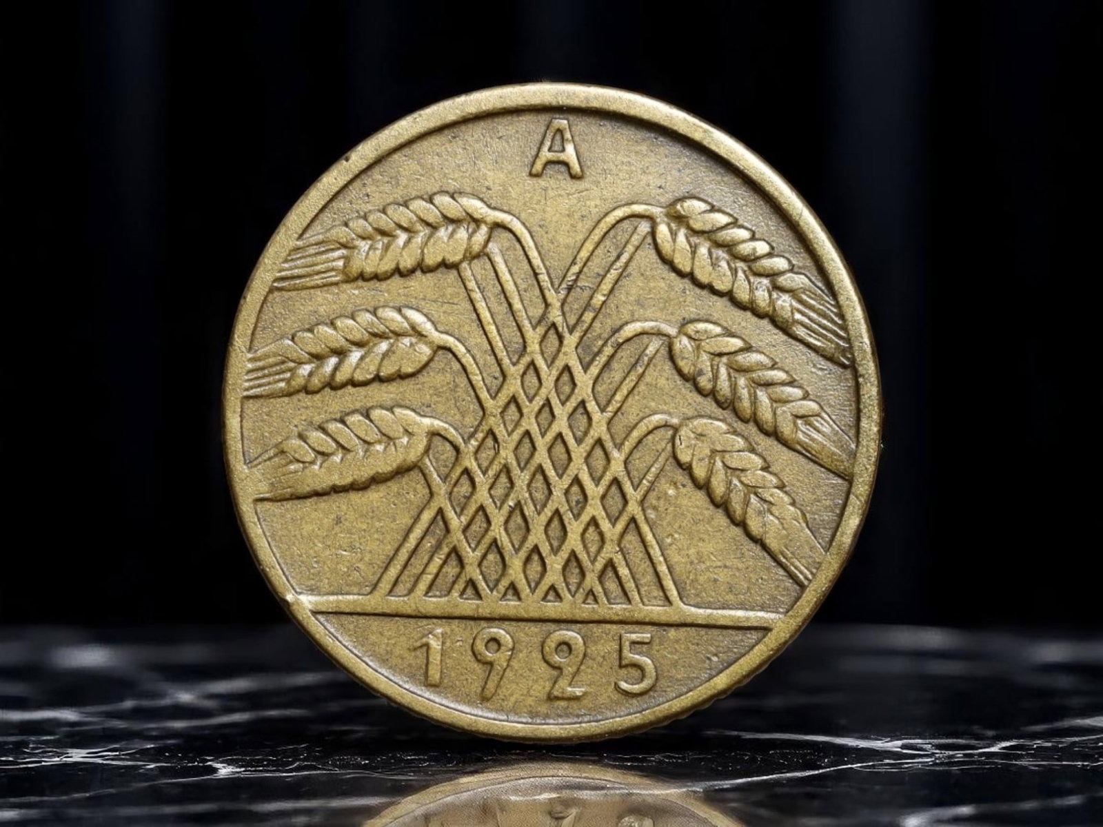 GERMANY/WEIMAR REPUBLIC Interwoven Grain Sheaves 10 Reichspfennig Coin, 1925 A Berlin Mint, 20mm: Struck in 1925 at the Berlin Mint, this 10 Reichspfennig coin offers a stylized vision of national cooperation through its striking depiction of six interlaced wheat stalks-an emblem of Germany's agri