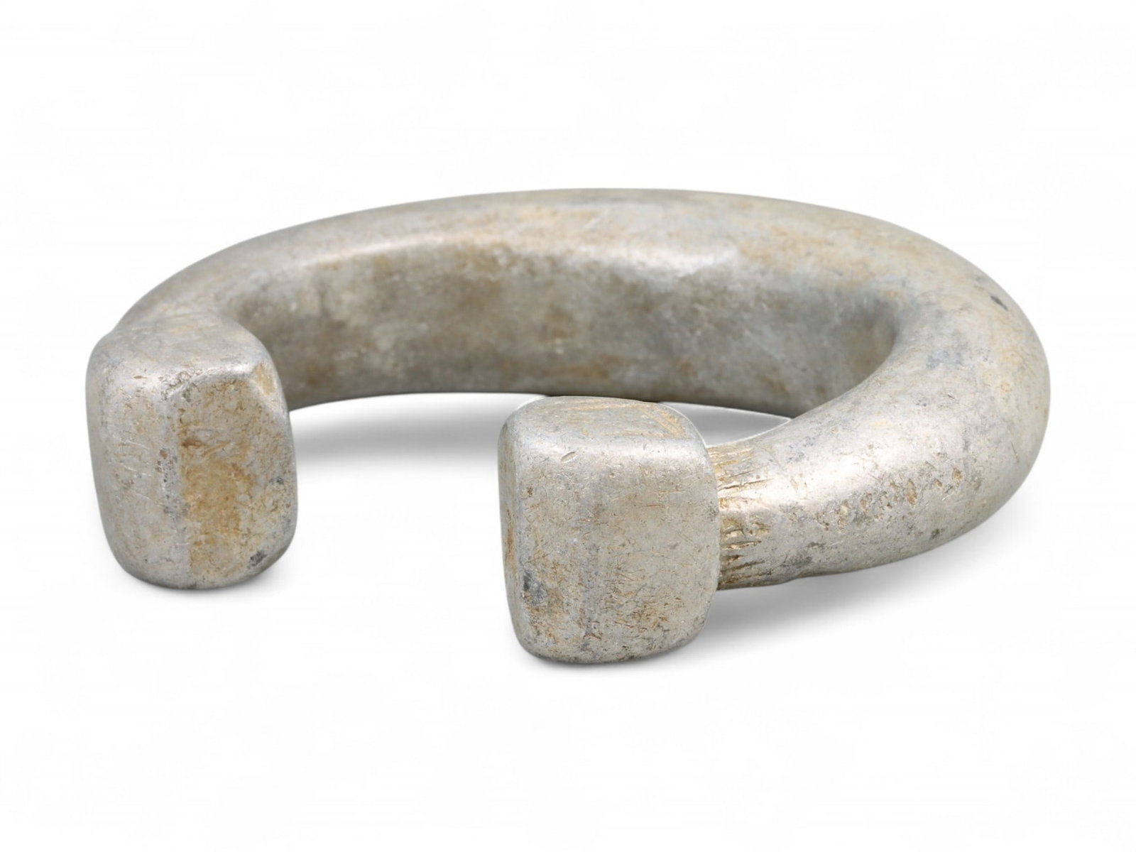 Post-Medieval West African Aluminum Bracelet with Geometric Terminals, c. 18th-19th Century CE: This substantial cast aluminum bracelet originates from West Africa, where metal adornments played a vital role in symbolizing wealth, status, and ancestral heritage. Dating to the 18th-19th century C