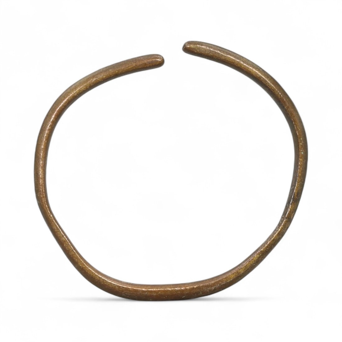 Ancient Roman Bronze Armilla Bracelet with Rounded Terminals, Empire-wide, c. 1st-3rd Century CE: This compact 4.8 cm (1.89 inch) diameter bronze armilla is a classic specimen of Roman-era wrist adornment, notable for its understated solidity and smoothly rounded terminals. The bracelet's circular