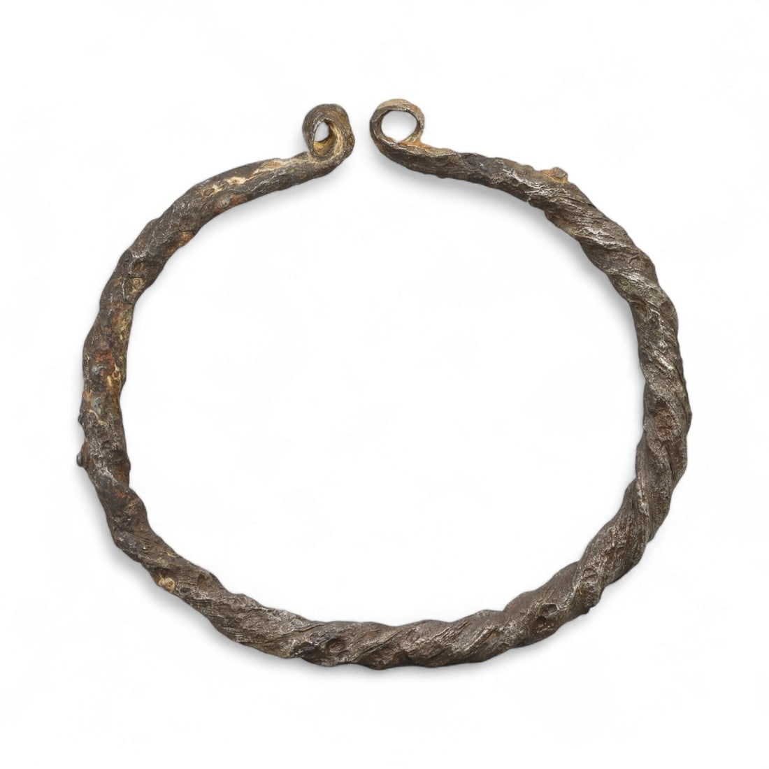 Ancient Early Medieval Twisted Iron Terminal-Loop Bracelet, c. 8th-10th Century CE: Forged in an era when artistry met utility, this Early Medieval bracelet is a striking example of blacksmith craftsmanship in iron-a material both utilitarian and symbolic during the transitional cent