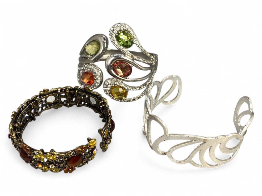 Timed Lot Auction - Decorative Bangle Trio in Mixed Styles and Finishes, Sold As Is: This listing features a trio of decorative bangles, each showcasing a unique aesthetic and crafted in varied materials and finishes. Offered as a single lot and sold exactly as shown in the photograph