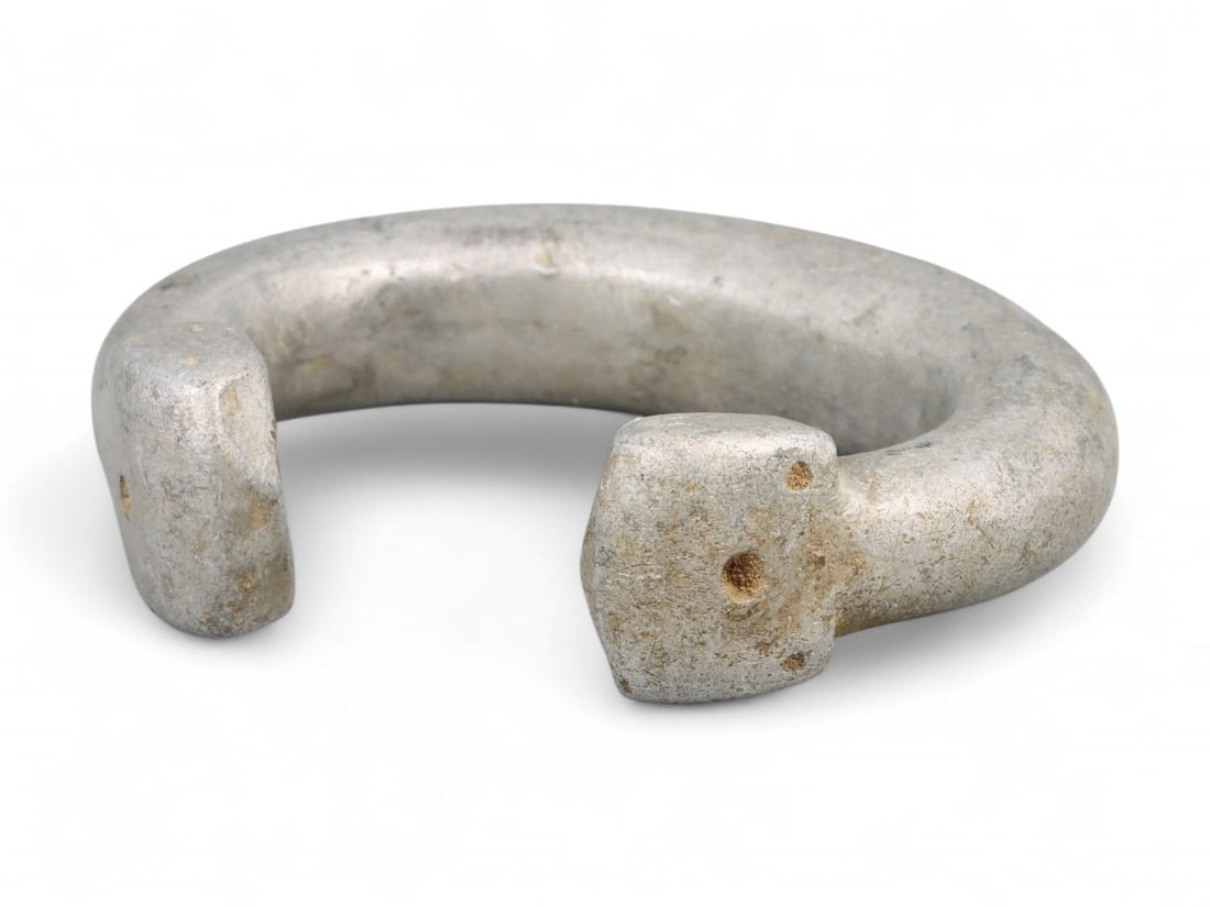 Post-Medieval West African Aluminum Trade Bracelet with Puncture Symbol Terminals, 18th-19th Century: This authentic aluminum currency bracelet, crafted in West Africa during the 18th-19th century, exemplifies a utilitarian form of adornment shaped by cultural and economic purpose. Measuring 7 cm (2.7