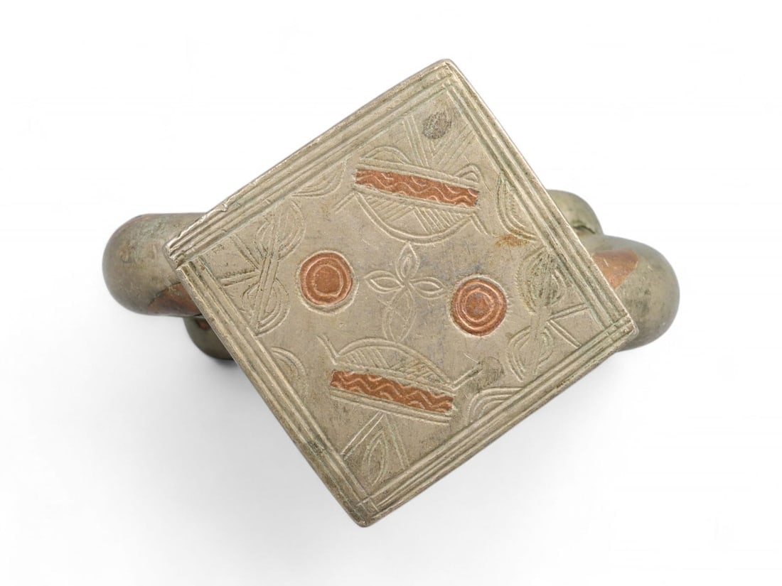 Post-Medieval North African Interwoven Cosmic Motifs Bi-Metallic Bracelet, c. 18th-19th Century CE: This commanding bi-metallic bracelet from post-medieval North Africa, dated to the 18th-19th century CE, represents a pinnacle of symbolic jewelry-making in Berber and Saharan traditions. Fashioned fr