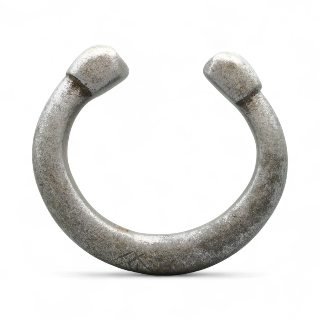 Antique West African Cast Aluminum Trade Bracelet, c. 18th-19th Century CE: This substantial cast aluminum bracelet from West Africa dates to the 18th-19th century CE and was likely used both as adornment and as a form of trade currency. Measuring 7.5 cm, the bracelet is defi
