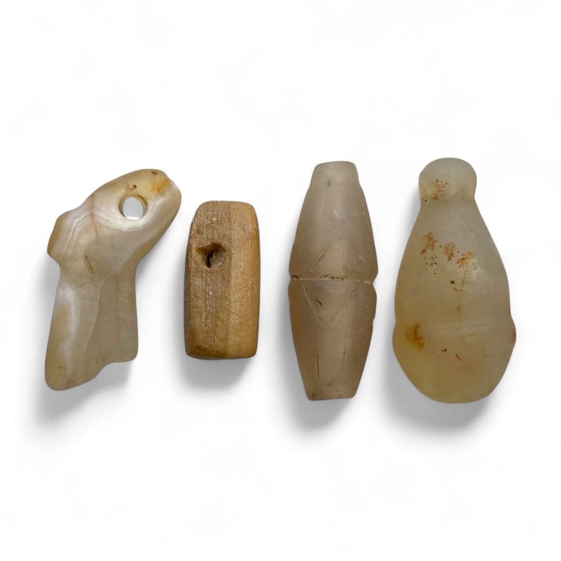 Ancient Sasanian Chalcedony and Stone Amulet Quartet, c. 3rd-6th Century CE, 29g: This subtle and spiritually charged quartet of amulets, carved in milky chalcedony and soft stone, originates from the culturally rich Sasanian Empire (c. 3rd-6th century CE). Measuring between 2 and 