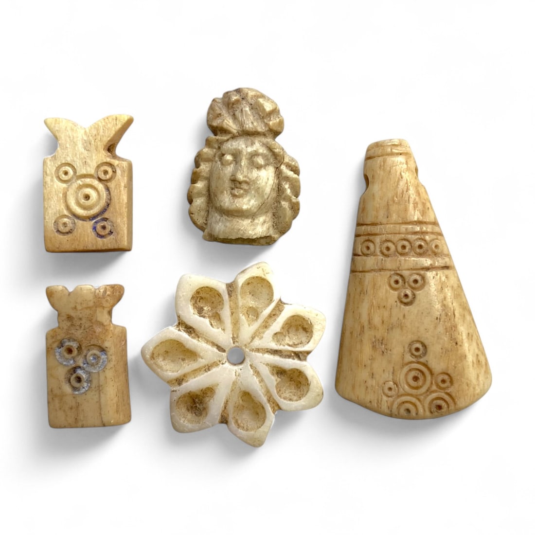 Ancient Coptic Egyptian Bone Amulets and Relics Set, c. 3rd-7th Century CE, 12g: This remarkable group of five miniature relics and amulets, delicately carved from bone, reflects the devotional and decorative artistry of Coptic Egypt during Late Antiquity. Ranging from 1.5 to 3 cm
