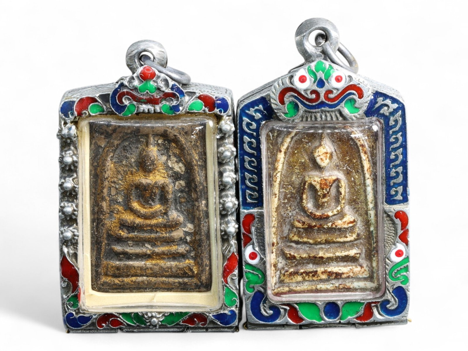 Antique Thai Gilded & Textured Buddha Terracotta Amulets in Silver Frames, c. 19th-20th Century, 73g: This well-matched pair of antique Thai terracotta amulets features classic seated Buddha motifs, one with traces of original gold leaf and the other marked by a rich, granular surface. Framed in vibra