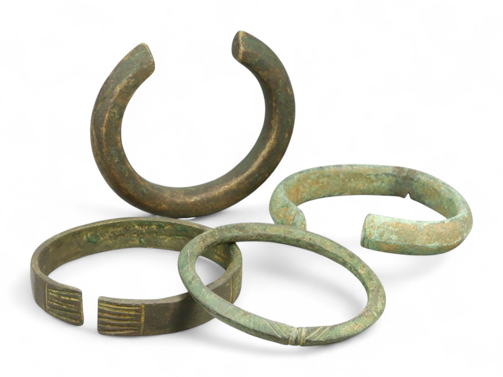 Ancient High Medieval Linear-Cut Bronze Cuff Bracelets Set, c. 11th-13th Century CE, 371g: This finely preserved set of four bronze bracelets hails from the High Medieval period, dating from the 11th to 13th century CE. Measuring between 7.3 and 7.9 cm in diameter and weighing a total of 37