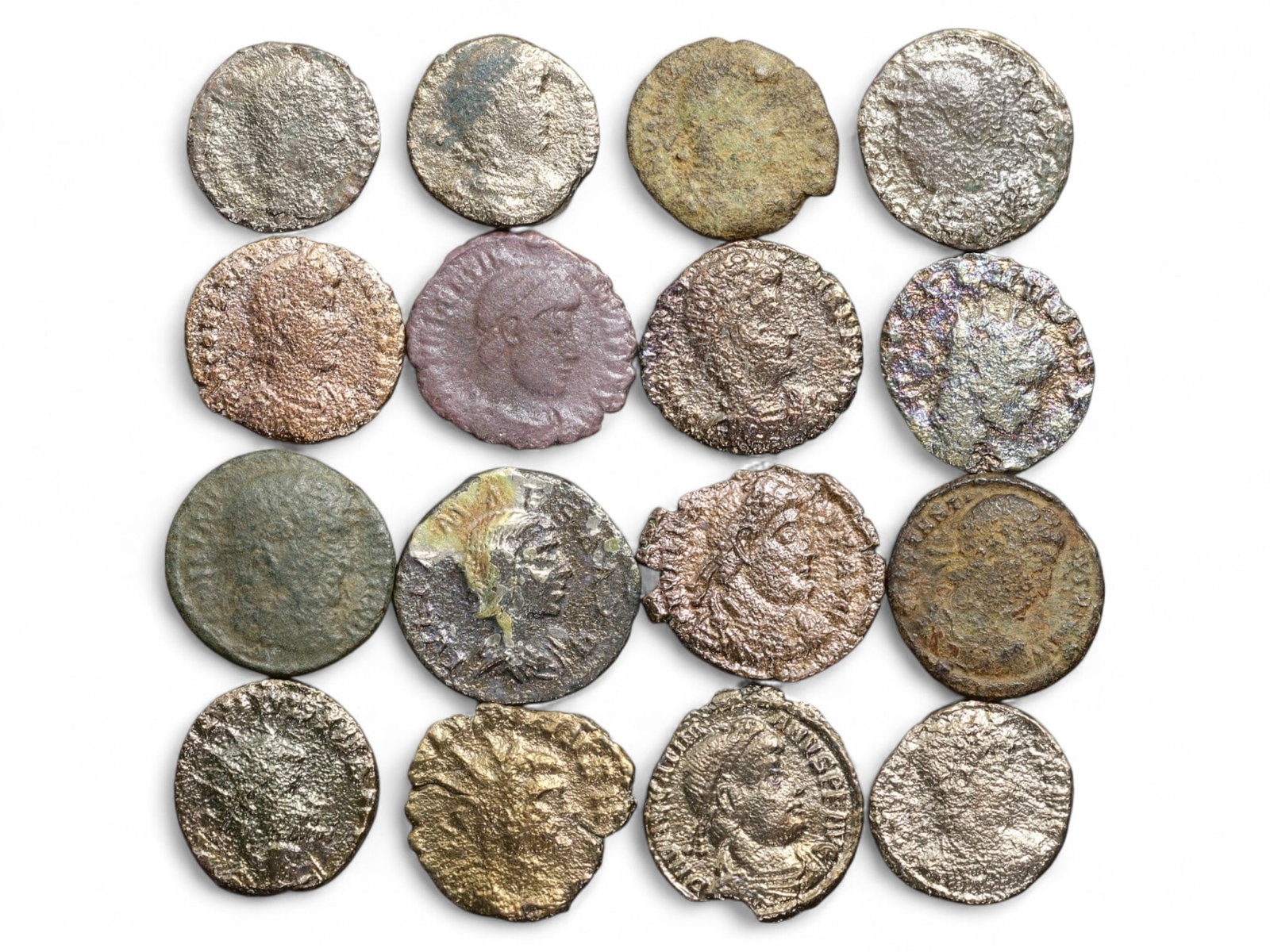 Ancient Roman 16-Coin Bronze Lot with Imperial Busts and Military Motifs, c. 3rd-4th Century CE, 33g: This diverse group of 16 ancient Roman bronze coins, totaling 33 grams (1.16 oz), showcases the wide iconographic and stylistic range of Rome's imperial currency during the turbulent 3rd to 4th centur