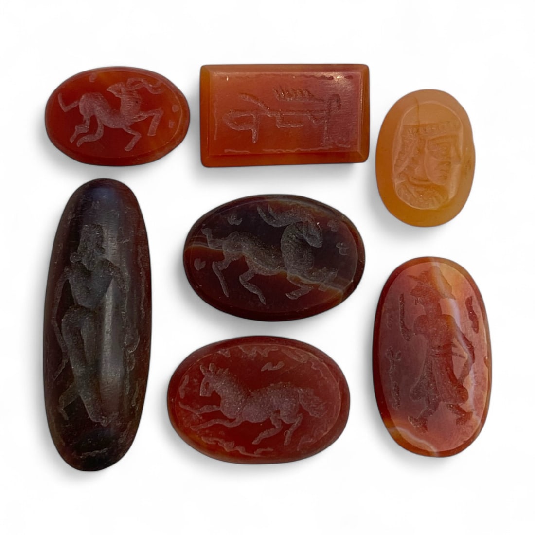 Ancient Sasanian-Islamic Carnelian Intaglio Seal Stone Collection, c. 6th-10th Century CE, 13g: This distinguished group of seven carved carnelian seal stones bridges the late Sasanian and early Islamic periods, dating from approximately the 6th to 10th century CE. With a total weight of 13 gram