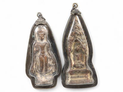 Antique Thai Standing and Seated Buddha Amulets, c. Early 20th Century, 71g: This dignified pair of antique Thai amulets, crafted in terracotta and set within patinated bronze-alloy casings, represents two of the most iconic postures in Thai Buddhist iconography: the standing