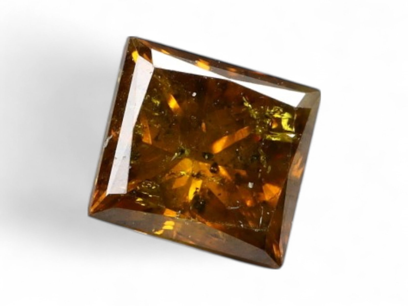 0.45ct Natural FANCY DEEP AMBER PRINCESS-CUT Diamond: This 0.45 carat natural princess-cut diamond glows with a rich deep amber hue, highlighted by golden-orange flashes and internal fire. Its sharp geometric silhouette and symmetrical lines offer a stri