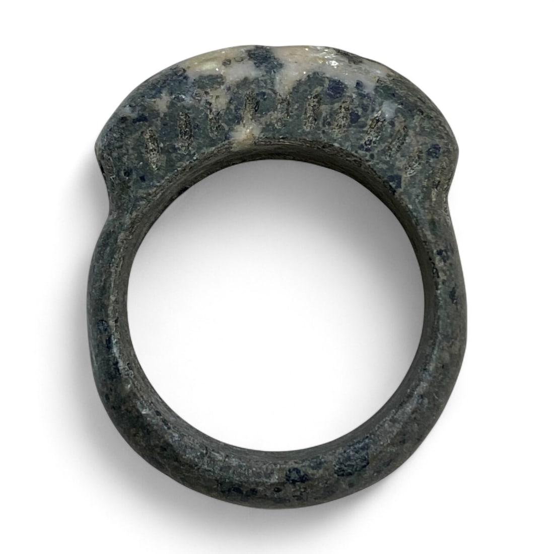 Ancient Near Eastern Domed Symbolic Stone Ring, c. 2nd Millennium BCE, 17g: This remarkable ancient stone ring, carved from dark veined stone with a prominent domed bezel, dates to the 2nd millennium BCE and likely originates from the broader Near Eastern region. With its sub