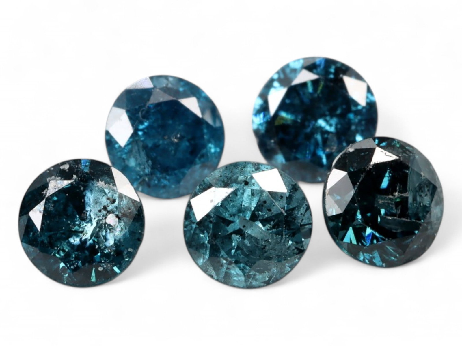 0.45ct Natural FANCY BLUE Diamond Lot - Round Cut, Irradiated, 2.8 mm each: This vibrant 0.45-carat parcel of round-cut diamonds features a dramatic range of deep oceanic blues, achieved through irradiation to intensify their natural brilliance. Each stone measures approximat