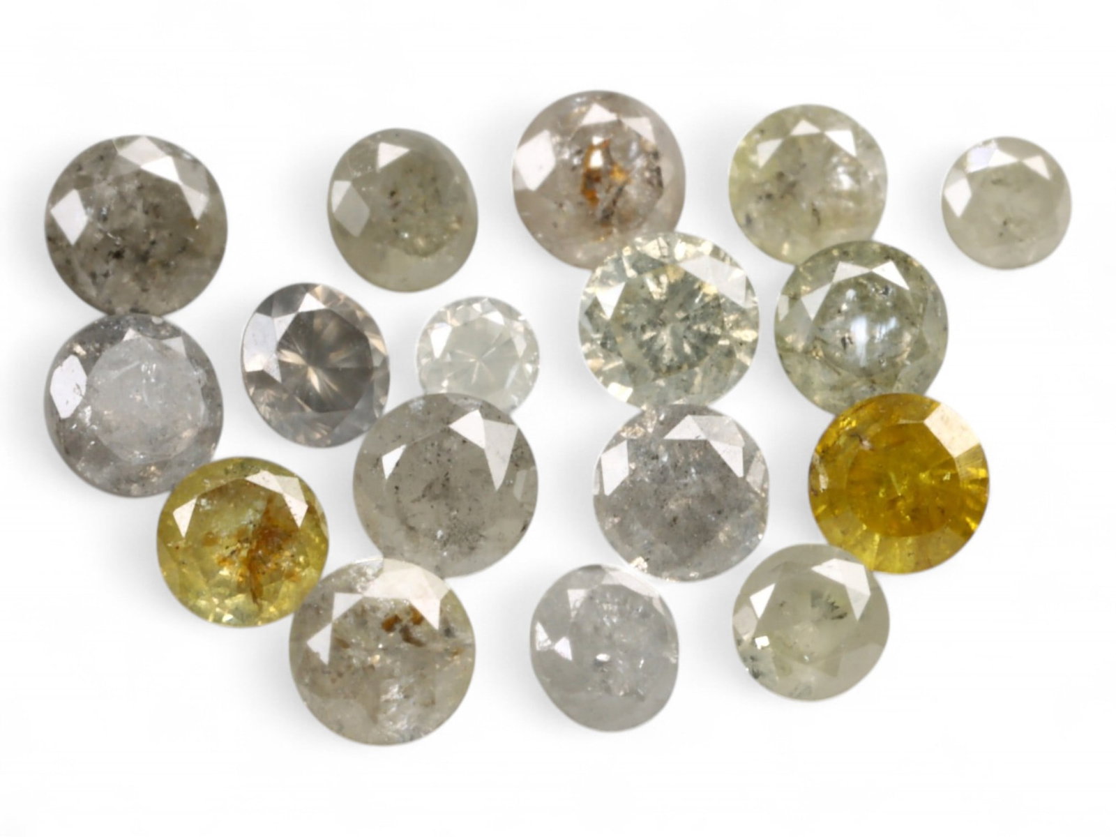 1.03ct Natural FANCY GREYISH YELLOW Diamond Lot - Round Cut: A subtly radiant parcel, this curated lot of natural round-cut diamonds displays an organic palette of greyish yellow tones with varied translucency and natural internal textures. The warm-to-cool spe