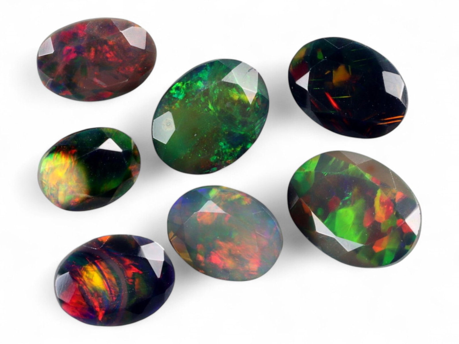 9.50Ct Natural ETHIOPIAN WELO Black Smoked Opal Faceted Parcel Lot: An alluring array of natural Ethiopian Welo black smoked opals, this parcel radiates with spectral fire and deep iridescence. Each gem is richly faceted to enhance the dynamic play-of-color-ranging fr