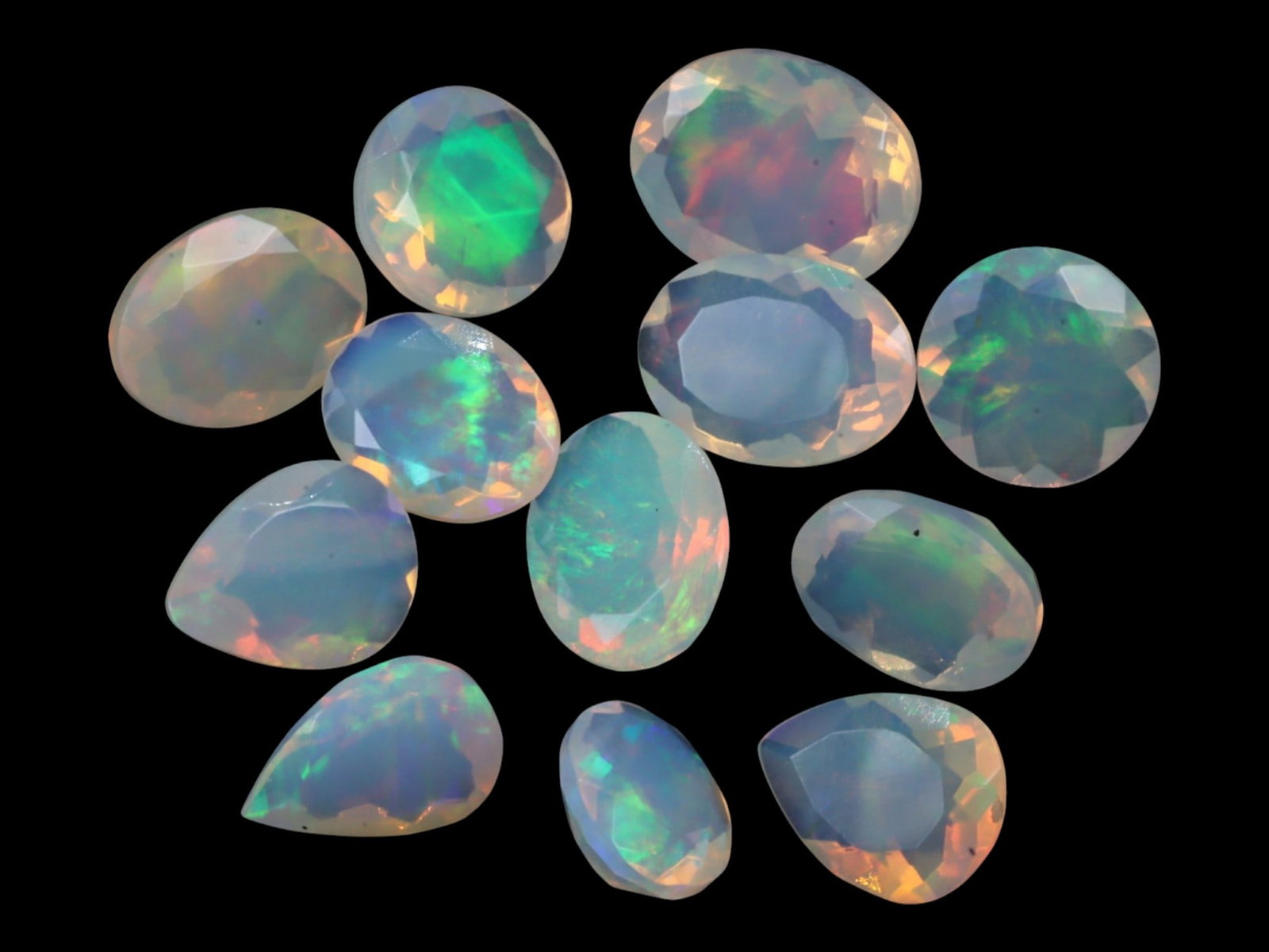 13.35Ct Natural ETHIOPIAN WELO White Opal Faceted Parcel Lot: This parcel of faceted Ethiopian Welo white opals offers a vibrant spectrum of pastel fire captured within crystalline translucence. Each stone showcases internal flashes of lime green, orange-peach, 