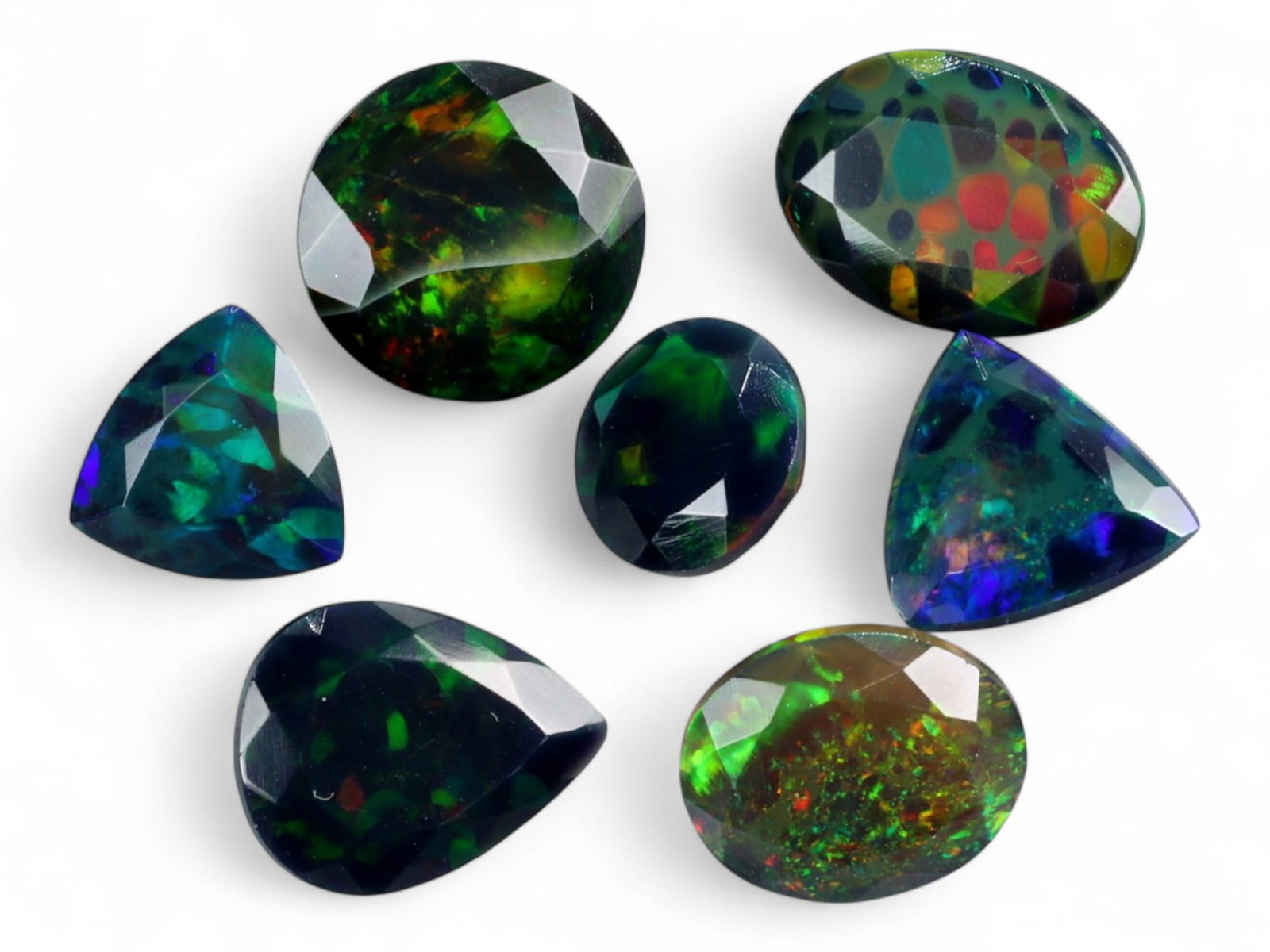 10.85Ct Natural ETHIOPIAN WELO Black Smoked Opal Faceted Parcel Lot: An alluring array of natural Ethiopian Welo black smoked opals, this parcel radiates with spectral fire and deep iridescence. Each gem is richly faceted to enhance the dynamic play-of-color-ranging fr