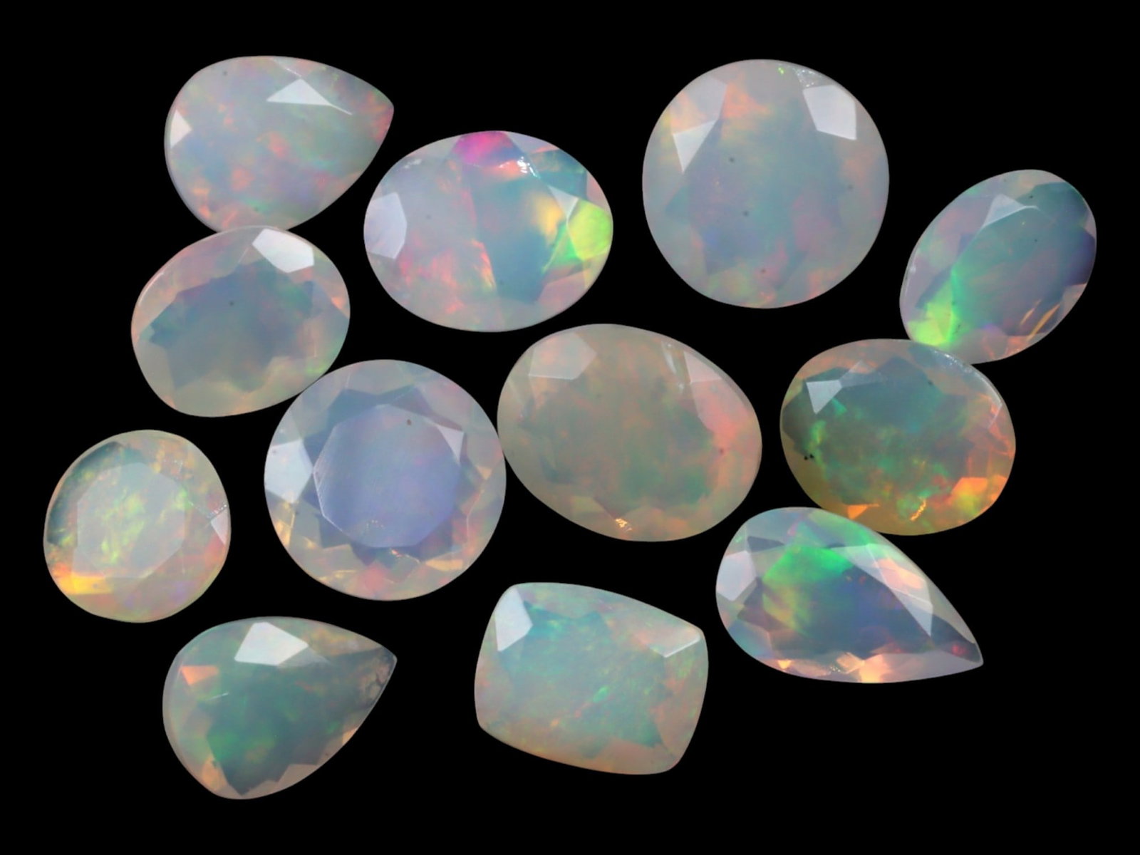 14.35Ct Natural ETHIOPIAN WELO White Opal Faceted Parcel Lot: This parcel of faceted Ethiopian Welo white opals offers a vibrant spectrum of pastel fire captured within crystalline translucence. Each stone showcases internal flashes of lime green, orange-peach, 