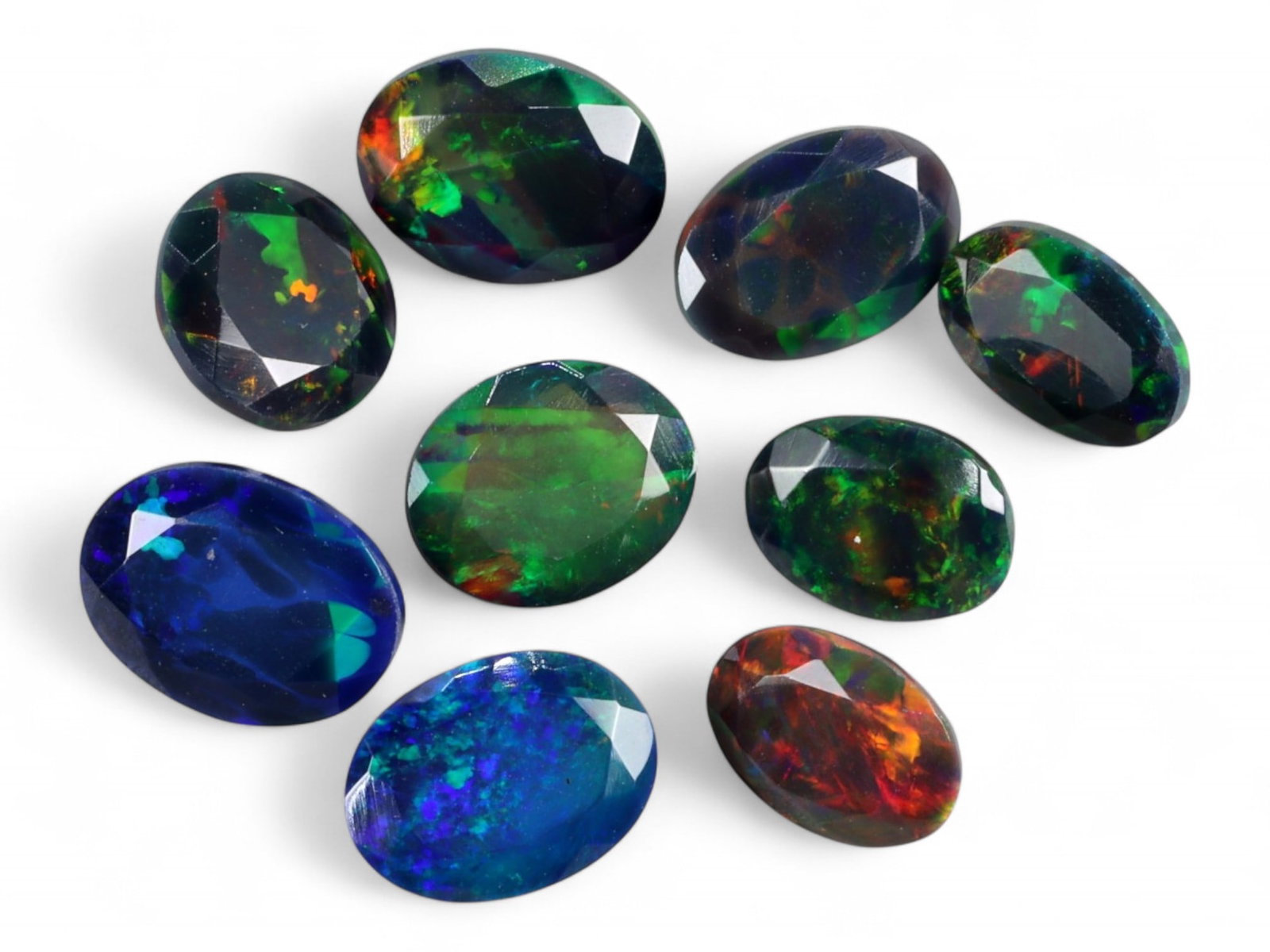 9.70Ct Natural ETHIOPIAN WELO Black Smoked Opal Faceted Parcel Lot: An alluring array of natural Ethiopian Welo black smoked opals, this parcel radiates with spectral fire and deep iridescence. Each gem is richly faceted to enhance the dynamic play-of-color-ranging fr