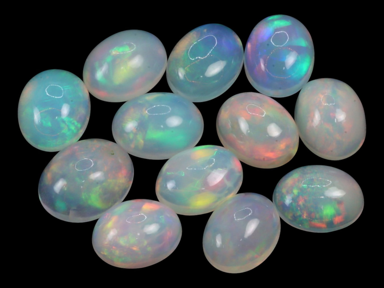 14.25Ct Natural ETHIOPIAN WELO White Opal Cabochon Parcel Lot: A luminous parcel of natural Ethiopian Welo white opals, each cabochon reveals an ethereal interplay of pastel brilliance within a translucent to milky-white body. The internal fire dances in flashes 