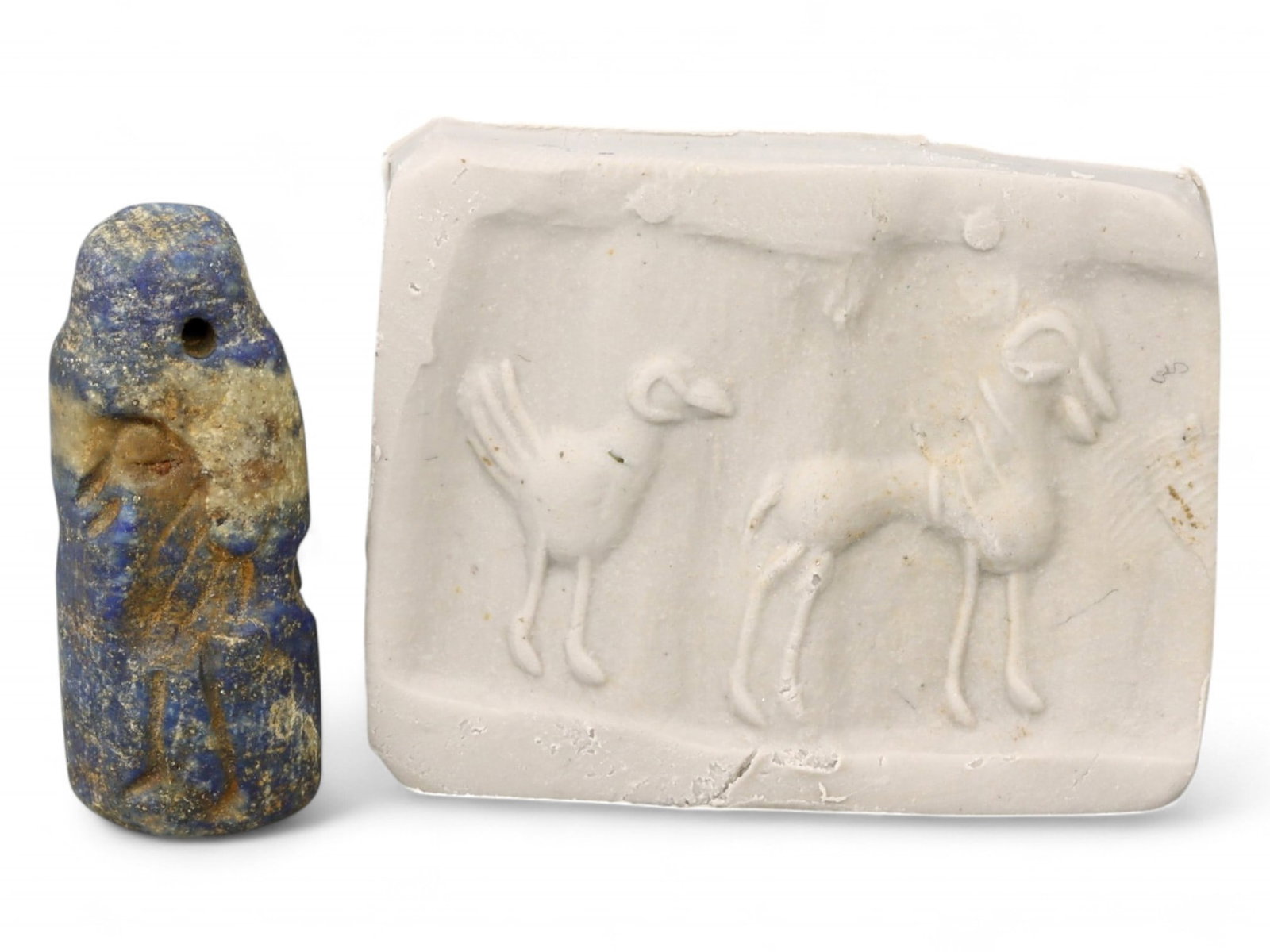 Ancient Akkadian Dual Ibex Cylinder Seal in Lapis Lazuli, c. 23rd-22nd Century BCE, 6g: This elegant cylinder seal, carved from radiant lapis lazuli and dating to the Akkadian period (c. 23rd-22nd century BCE), features two ibexes in poised stance, surrounded by circular celestial motifs