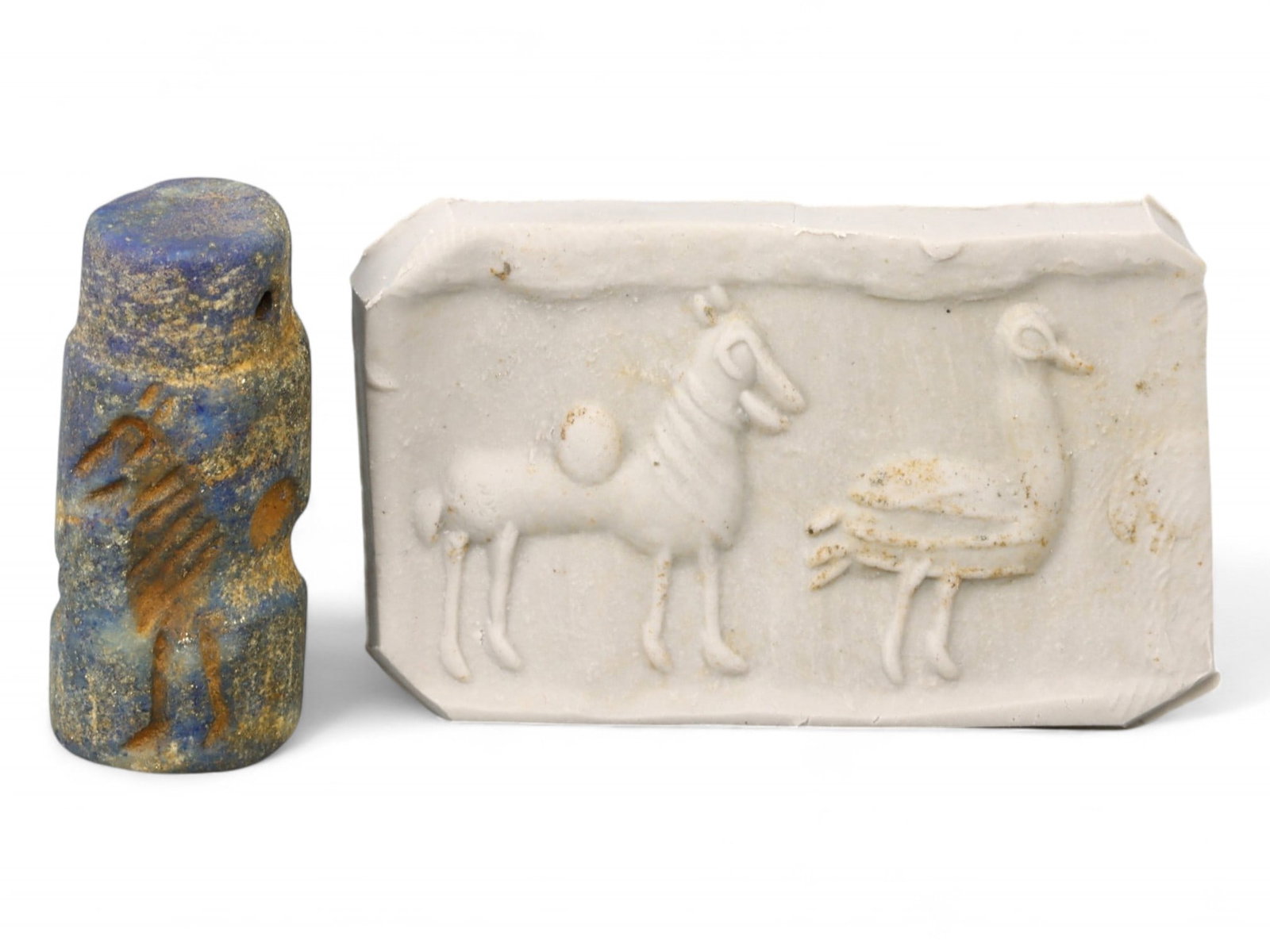 Ancient Akkadian Ram and Waterfowl Cylinder Seal in Lapis Lazuli, c. 23rd-22nd Century BCE, 9g: This striking lapis lazuli cylinder seal from the Akkadian period (c. 23rd-22nd century BCE) depicts a finely incised ram and a long-necked waterfowl, captured in a moment of quiet symbolism. Measurin