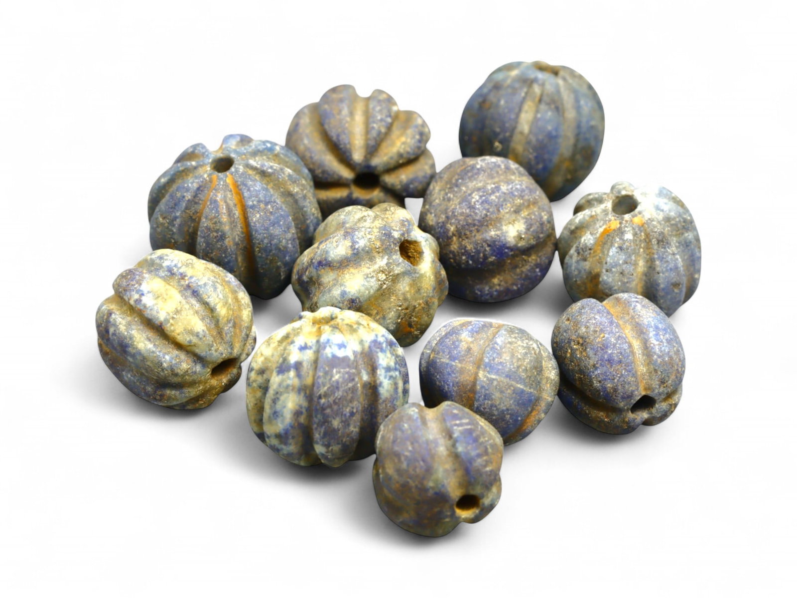 Ancient Egyptian Melon-Shaped Lapis Lazuli Bead Set, c. 18th Dynasty, 39g: This remarkable group of ancient melon-shaped beads, exquisitely carved from lapis lazuli, dates to the Egyptian New Kingdom, likely during the 18th Dynasty (c. 1550-1295 BCE). Their elegant ridged fo