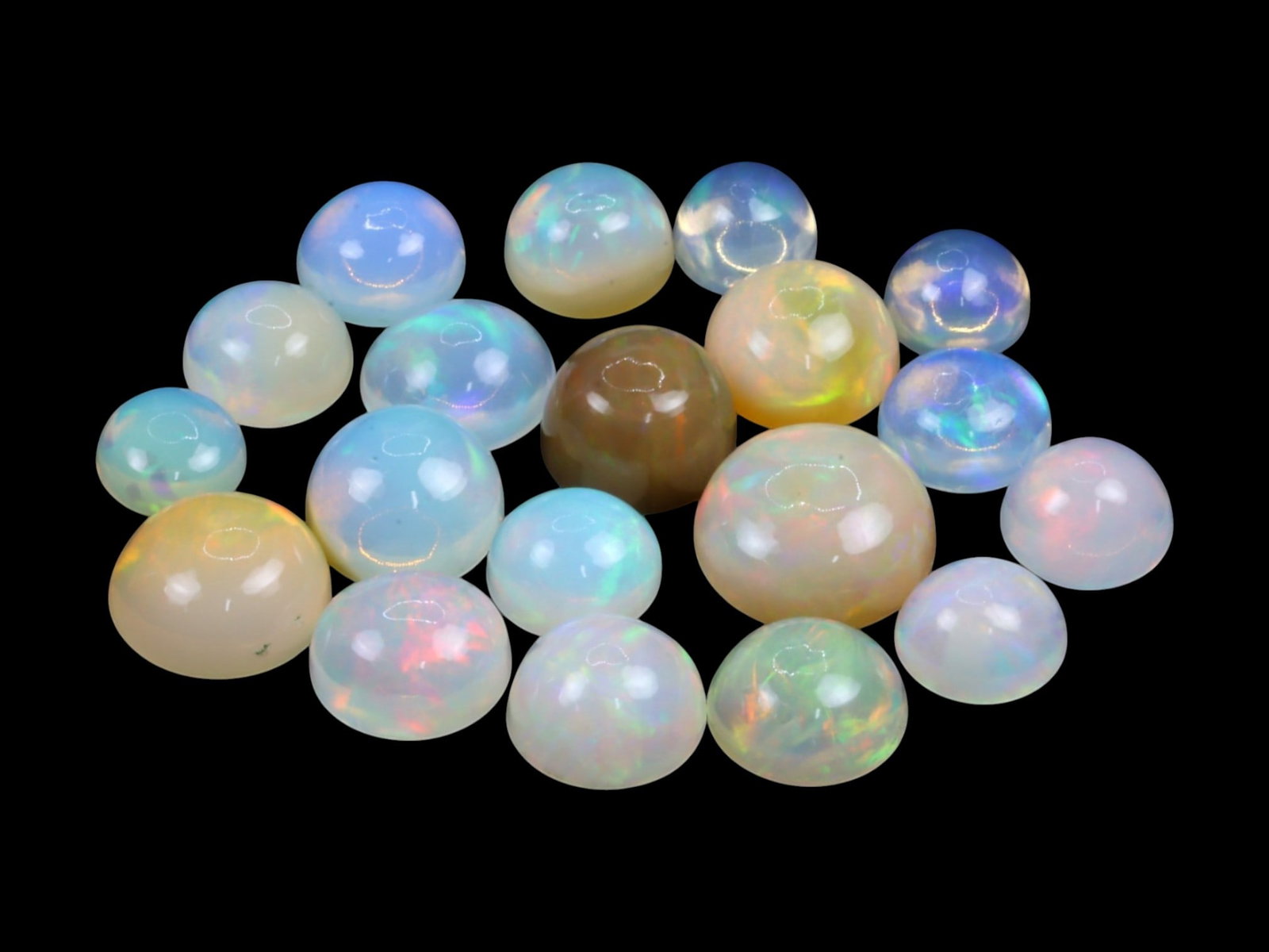 22.05Ct Natural ETHIOPIAN WELO Opal Cabochon Parcel Lot: This parcel of natural Ethiopian Welo opal cabochons presents a dreamy spectrum of translucent domes with luminous internal fire. The cabochons glow with pastel flashes-mint green, lavender, coral, an