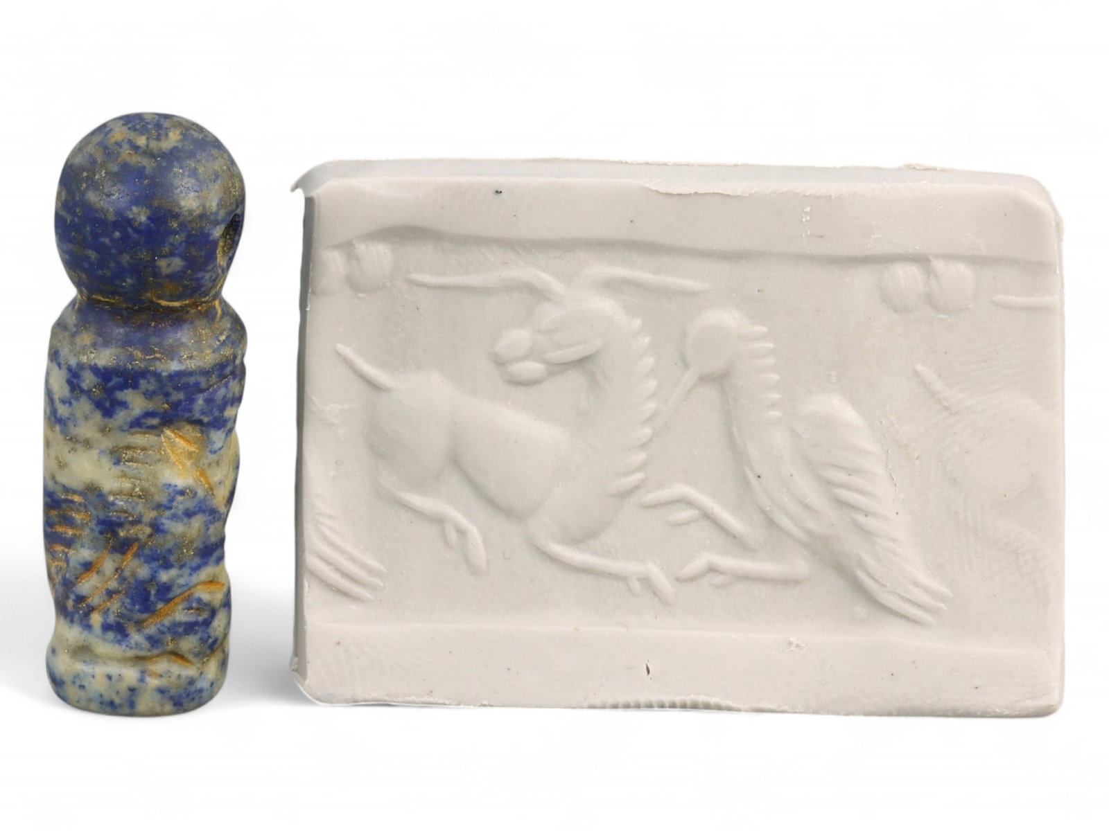 Ancient Akkadian Ibex and Bird Cylinder Seal in Lapis Lazuli, c. 23rd-22nd Century BCE, 7g: This striking cylinder seal from the Akkadian period presents a finely carved ibex locked in dynamic motion beside a tall crested bird, likely a crane or heron-both animals rich in Mesopotamian symbol
