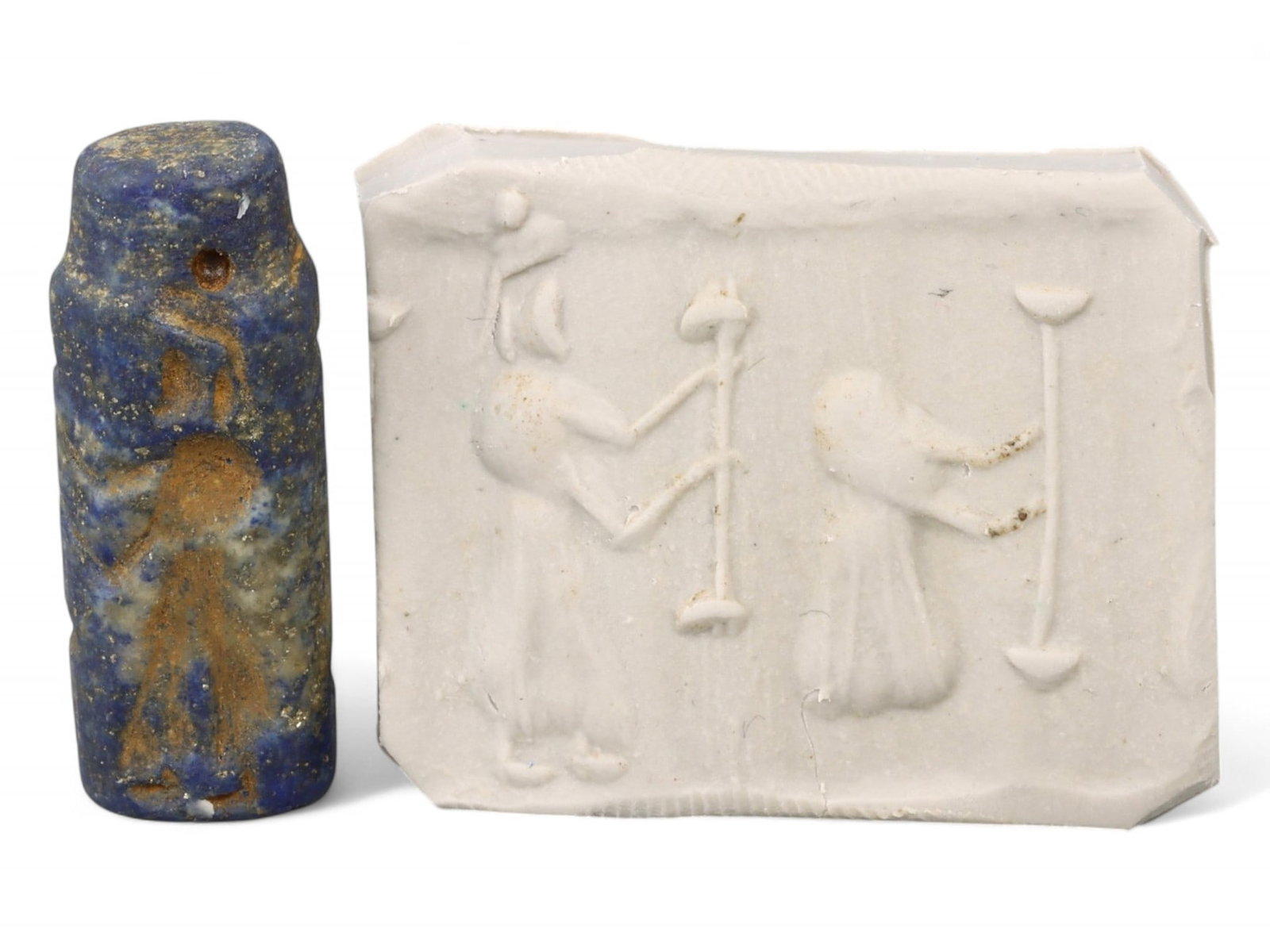 Ancient Akkadian Worship Scene with Divine Standards Lapis Lazuli Cylinder Seal, 2350-2150 BCE, 7g: This evocative Akkadian cylinder seal, crafted from luminous lapis lazuli, features a compelling scene of spiritual reverence: a robed worshipper stands before two upright standards-likely divine embl