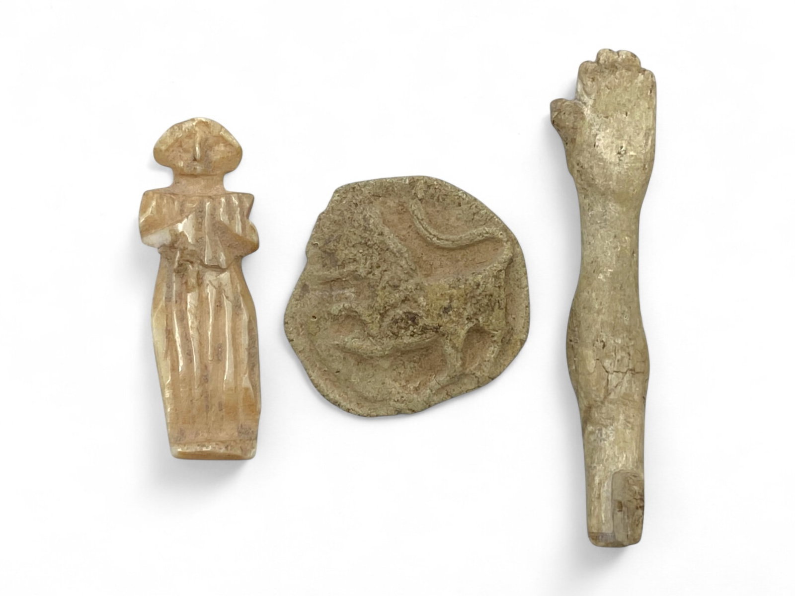 Ancient Coptic Egyptian Carved Bone Devotional Figurine, Medallion, and Limb, 4th-7th Century CE, 9g: This evocative trio of carved bone relics from Coptic Egypt dates to approximately the 4th-7th century CE, a transitional period rich in early Christian symbolism and devotional practice. Weighing a c