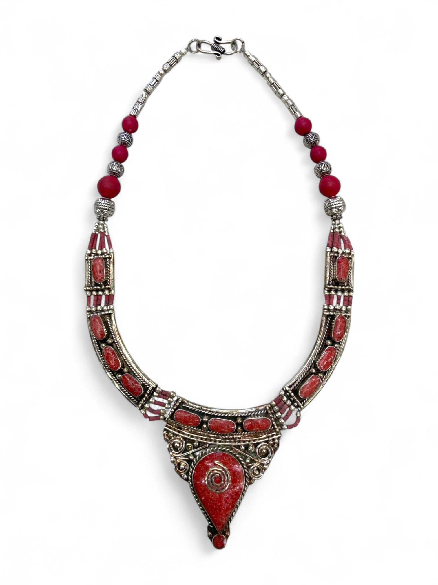 Antique Himalayan Tribal Silver Necklace with Red Coral Inlays, 119g: This striking antique necklace is a bold testament to the ornamental traditions of Himalayan tribal cultures, showcasing masterful silverwork accented with vivid red coral inlays. Likely dating to the