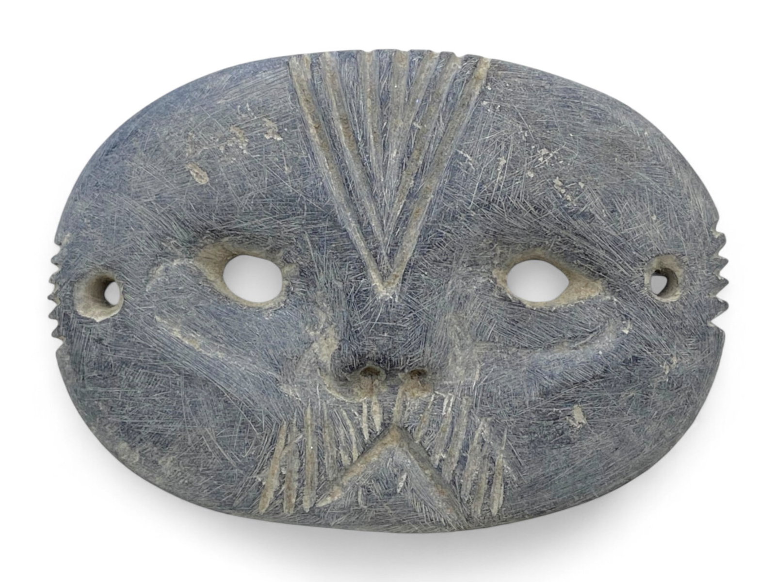 Ancient Near Eastern Tribal Schist Mask Amulet with Geometric Carving, c. 1st Millennium BCE, 130g: Carved from dark schist and measuring 10 x 7 cm with a weight of 130 grams, this ancient mask amulet embodies a rare and enigmatic tradition from the tribal cultures of the ancient Near East or possib