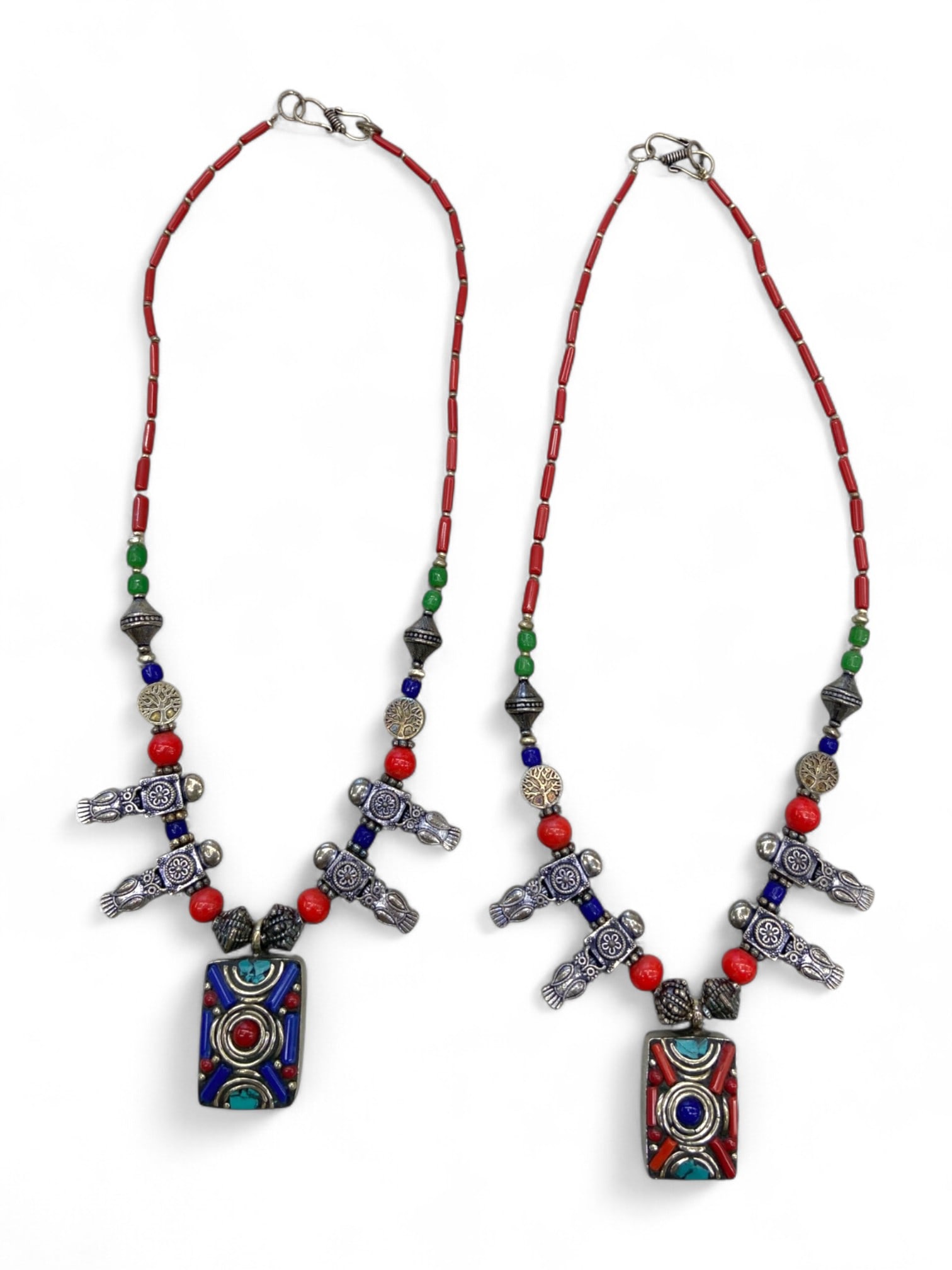 Pair of Vintage Totemic Symbol Red Beaded Amulet Necklaces, 113g: This vibrant matched pair of vintage necklaces captures the bold spirit of tribal artistry through rich color, symbolic charm elements, and rhythmic beadwork. Each piece features a distinctive rectang