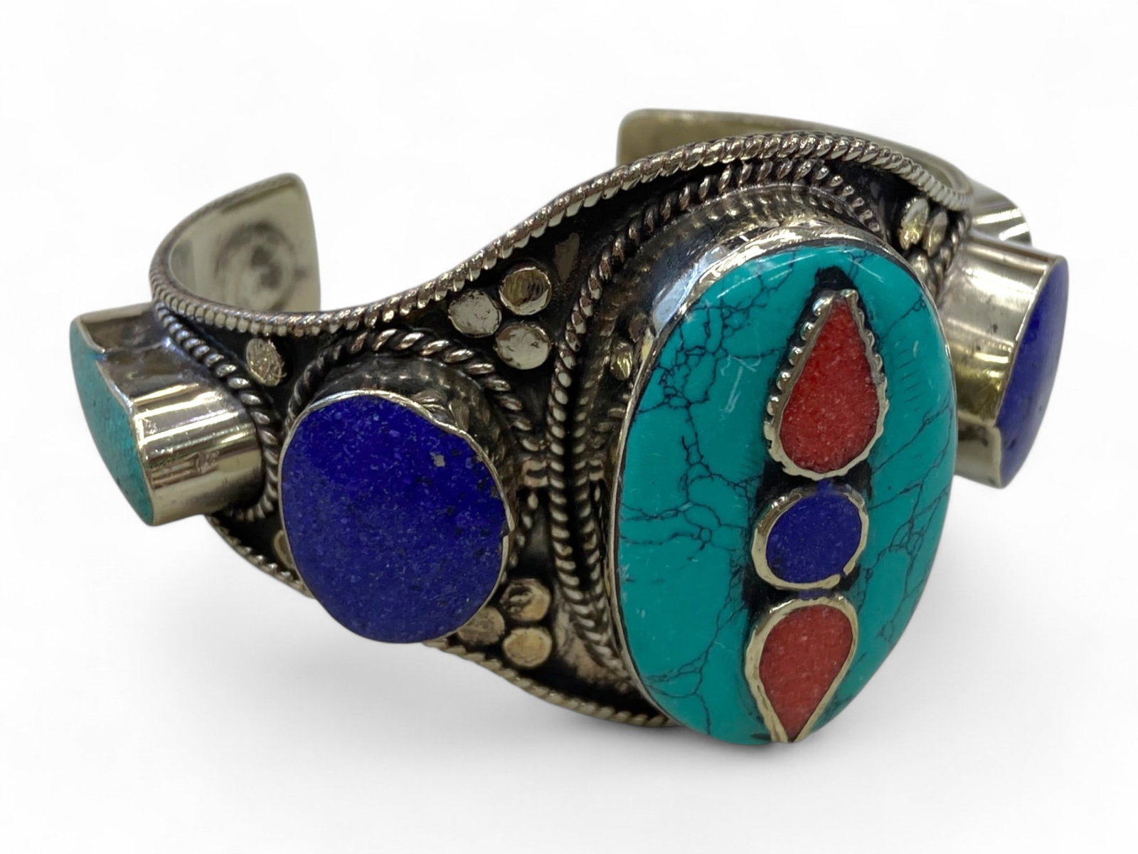 Post-Medieval Eastern Ritual Cuff Bracelet with Turquoise Inlay and Tricolor Symbolism, 176g: This visually arresting post-medieval Eastern cuff bracelet is a powerful example of symbolic design and traditional craftsmanship from Central or South Asian regions, where such pieces were imbued wi