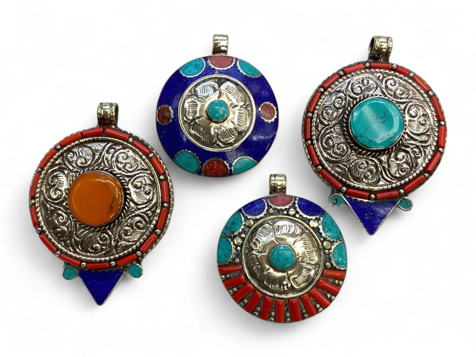 Antique Himalayan Tribal Mandala Pendants in Silver Alloy, c. 20th Century, 197g: This vibrant collection of four large tribal pendants, dating to the mid-20th century, represents the rich ornamental tradition of the Himalayan regions-most notably Nepal and Tibet. Ranging from 6 to