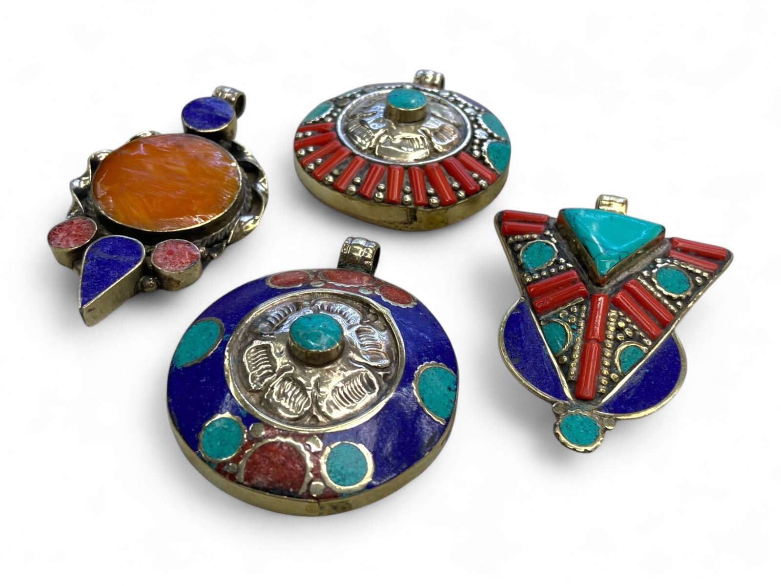 Antique Himalayan Tribal Mandala Pendants in Silver Alloy, 155g: These striking antique pendants exemplify the vivid spirituality and aesthetic richness of Himalayan tribal art. Crafted in silver alloy and inlaid with brilliant tones of coral red, turquoise blue, a